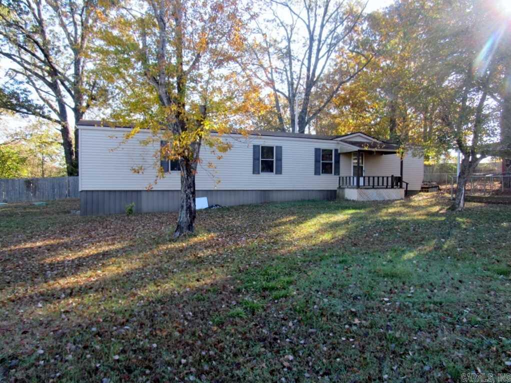 This is a nice double wide mobile home on 1.5 acres. Has enough land to put another mobile on it if needed. This 2 bedroom 2 bath mobile has been well taken care of. It has a carport and has chain link fence around yard for your pet. The open  formal living room and kitchen with lots of cabinets and built in stereo in cabinets. The master bedroom has walk in closet and large mst bath with separate commode room. Has a deck on the front and on the back.