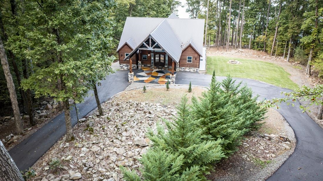 So many features to this Modern Log Sided Lakefront Home sitting on 3.06 ac.(m/l) w/gated entrance at the end of the cul-de-sac & Guest Home(26x60 H&C).This would make a great Vacation Rental Property.Main Home has approx. 3,304 sqft,2 gas fireplaces,10x12x12 concrete capsulated safe room w/heated floors,heated floors in all bathrooms & in living room,Exterior Audio & Video,outdoor shower,automatic power outage generator,6" exterior stud walls, & entire structure insulated w/open cell insulation (See more..