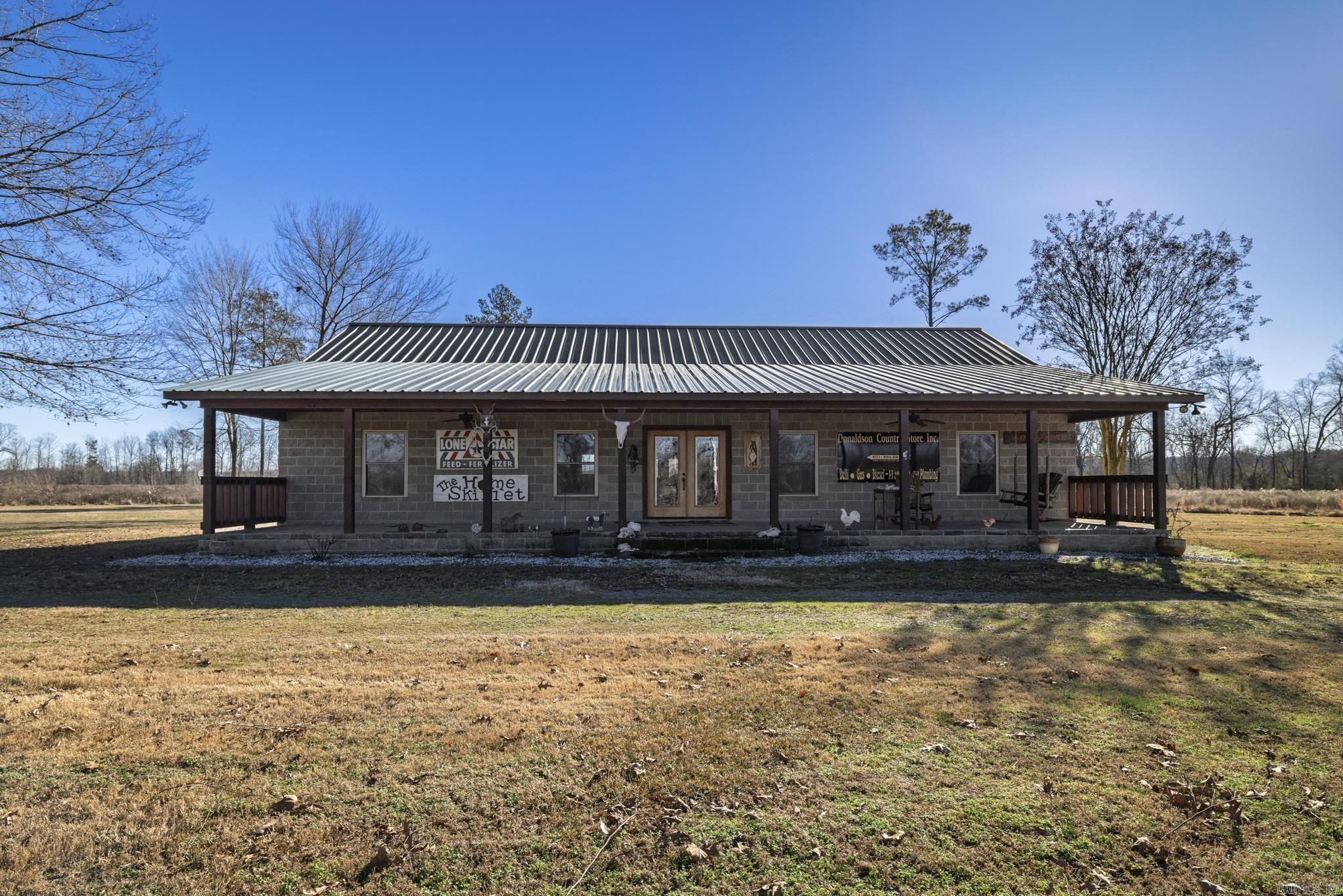 Discover an extraordinary blend of comfort, privacy, and natural beauty at 100 Lake Rd in Donaldson, Arkansas—a rare 138.9-acre riverfront estate featuring nearly 1,200 feet of Ouachita River frontage. The property is anchored by a spacious 4-bedroom, 2.5-bath home with approximately 2,400 sq ft, offering a welcoming layout ideal for family or guests. Surrounded by towering trees, rolling terrain, and scenic open fields, the home provides peaceful views that evolve with every season.  Outside, the land is a true outdoor enthusiast’s dream with roughly 20 acres of uncut pine, additional replanted pine, and an extensive trail system perfect for exploring, hunting, or riding. A stunning 15-acre stocked pond offers fishing, wildlife viewing, and quiet moments of reflection, while the expansive river frontage invites kayaking, paddling, or sunset walks along the water.  Whether you’re seeking a private retreat, a premier hunting property, or a legacy investment, this one-of-a-kind Arkansas property delivers unmatched privacy, abundant wildlife, and breathtaking riverfront living—secluded, yet within reach of modern conveniences.