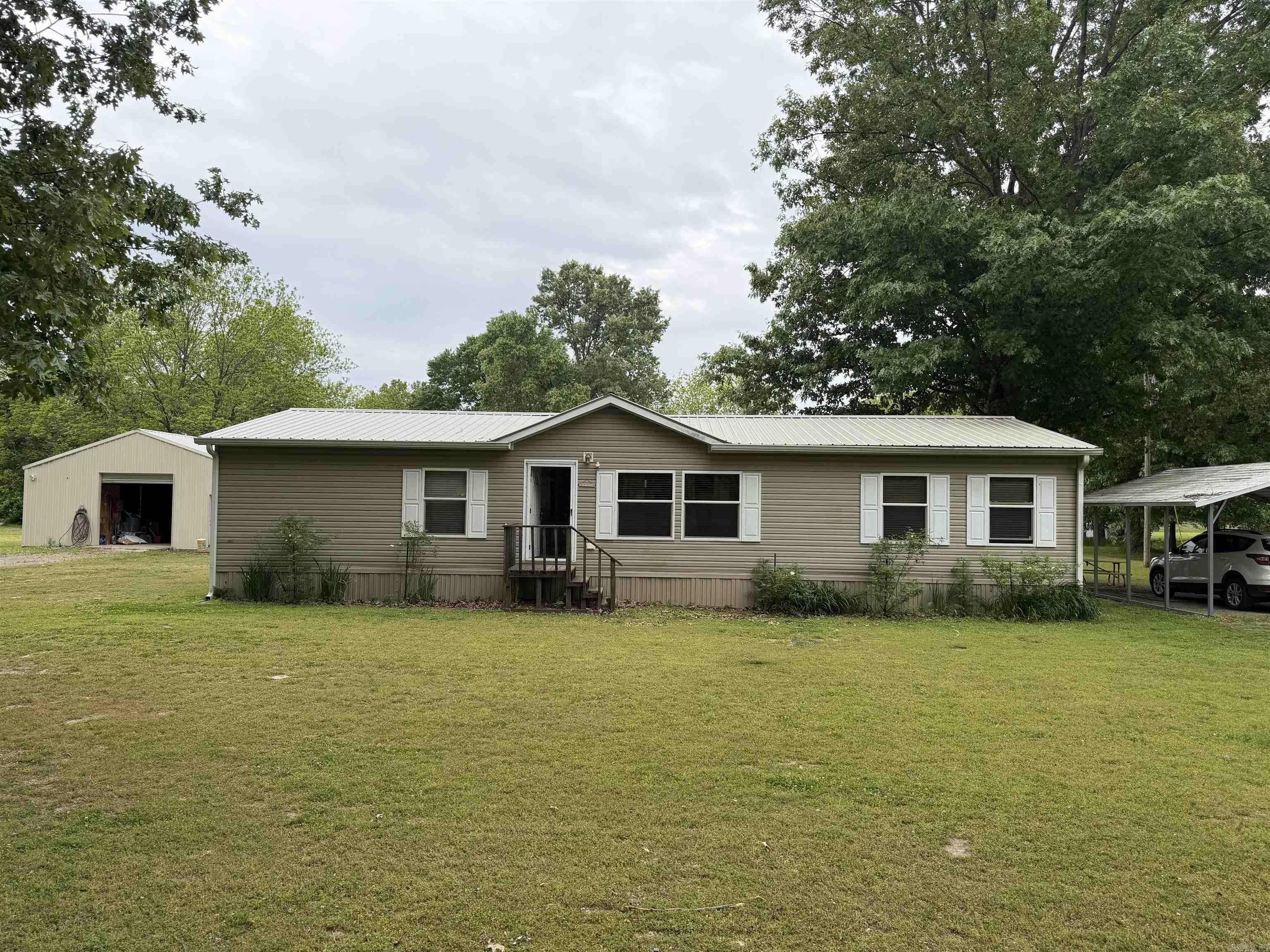 Welcome to your own slice of quiet country living! This well-maintained 4-bedroom, 2-bath home offers 1,512 sqft of comfortable space, perfectly situated on just under 2 acres in a peaceful, highly desirable outdoor recreation area. Step inside to find a warm and inviting interior featuring updated flooring, a spacious living area, and plenty of natural light. The functional layout provides ample room for family, guests, or even a home office setup. Outside is where this property really shines. Enjoy wide-open, level land with endless possibilities—gardening, entertaining, or simply relaxing in the fresh air. The impressive 30’ x 40’ shop with an additional 20’ lean-to and shower provides abundant space for equipment, hobbies, storage, or a workshop setup. Located just minutes from the White River and Little Red River, this property is a dream for outdoor enthusiasts—offering world-class fishing, hunting, and year-round recreation right at your fingertips. All of this while still enjoying the charm and tranquility of small-town living. Whether you’re looking for a full-time residence, weekend retreat, or investment opportunity, this property checks all the boxes.