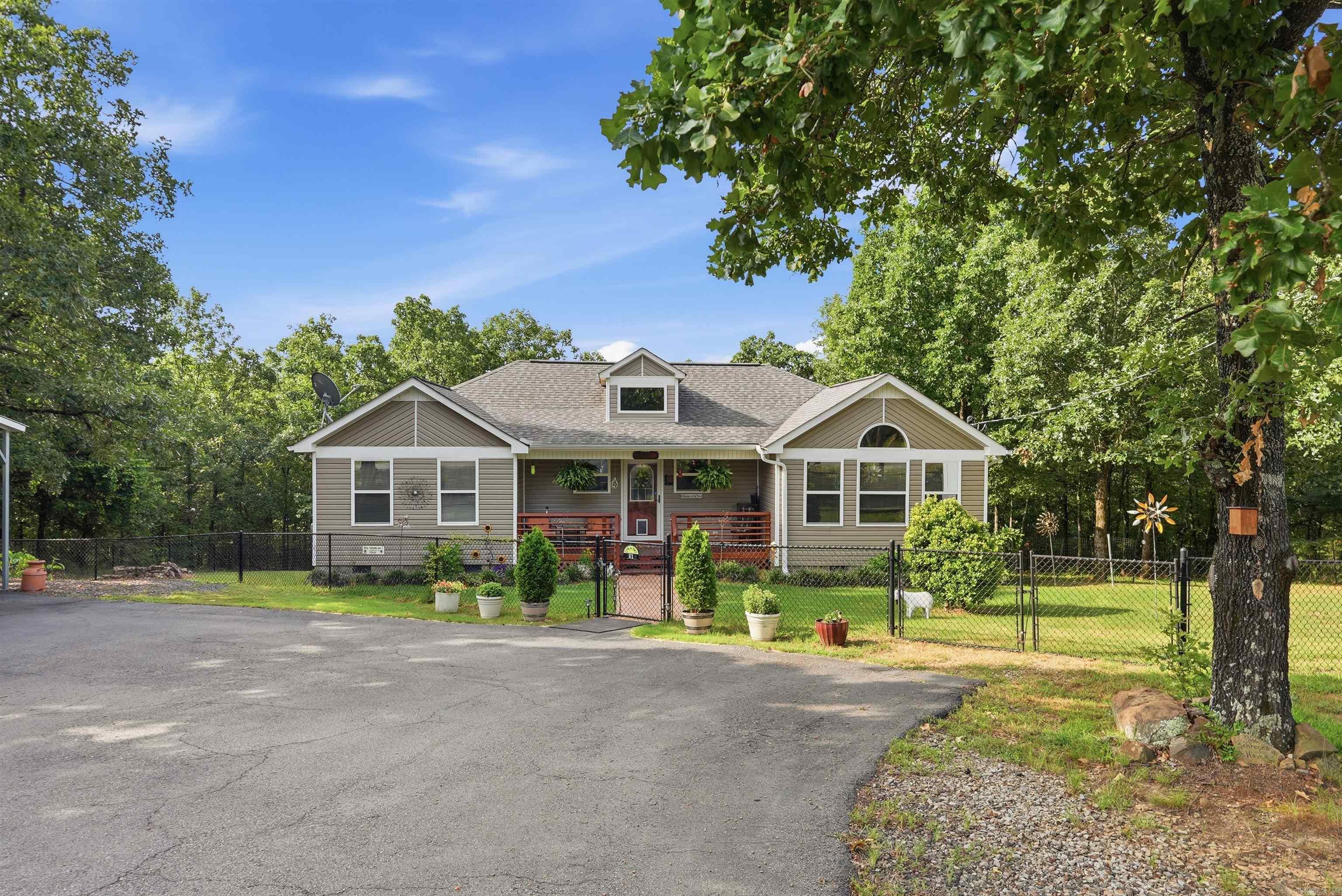 Gorgeous home on 2.5 Acres with solar panels, a 360 square foot shop with electricity and an overhead door, a partial wrap-around deck, and split floor plan!! This residence has been well-maintained and is ready for its new owners. Sitting amongst trees on a hill, this home feels like one with nature while still being less than 7 miles to Vilonia schools, grocery stores, and restaurants allowing you to enjoy privacy and the outdoors without sacrificing comfort and convenience. Key features include a walk-in storm shelter that can easily fit 4-6 people, new living room floors installed 2023, updated microwave, a 2 year old roof, high ceilings in the living room, a black chain link fence around the property, and an ADT security system. Electricity bills average $13 a month a here according to the owners! Solar panels will be paid off at closing. Call now to schedule a tour!