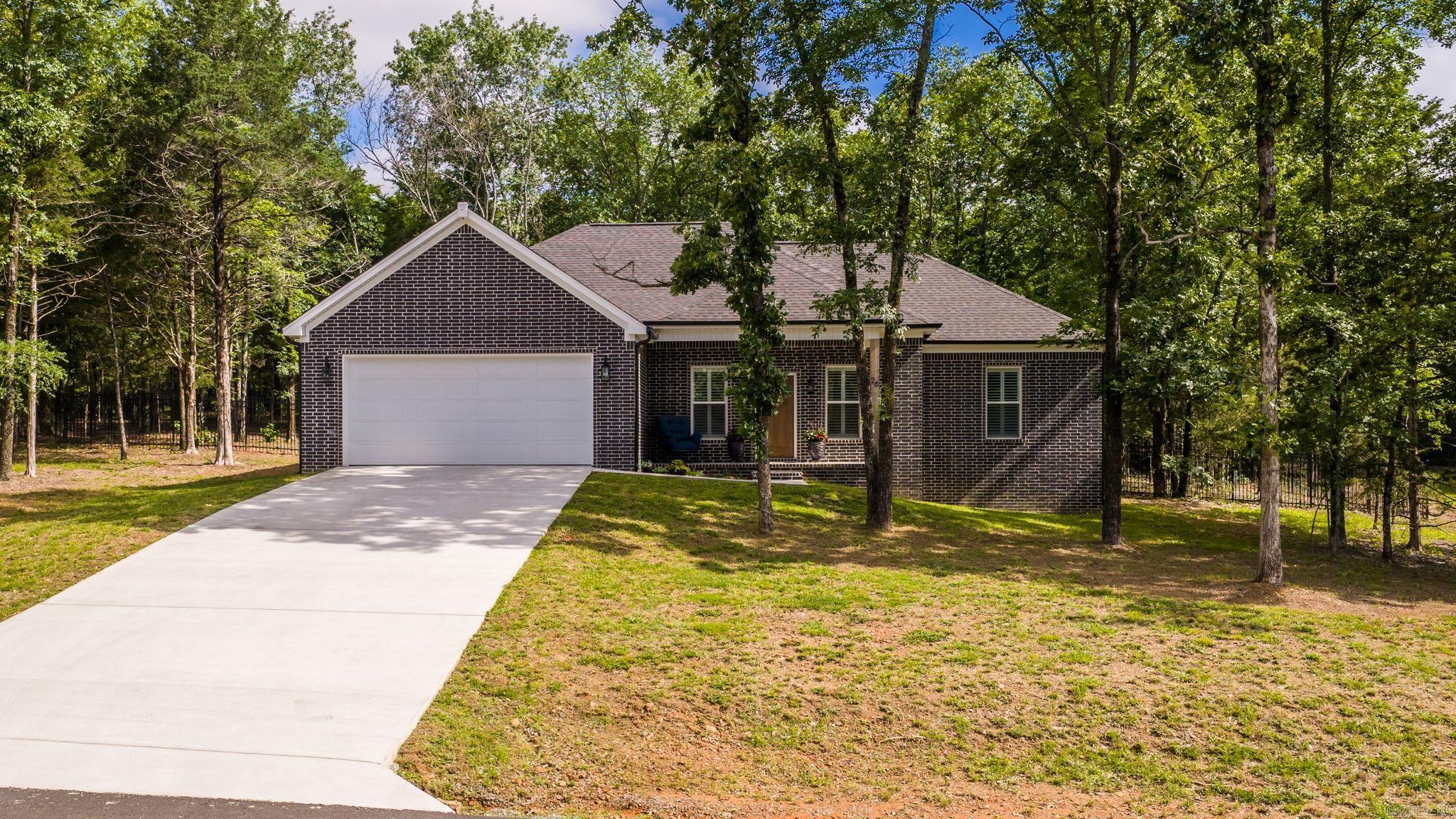 Beautiful 2024-built home on 1.08 mostly wooded acres with a private backyard and quality owner upgrades! Tucked away on a quiet dead-end street with little traffic, this home offers the feel of a peaceful country setting while still being conveniently located. Inside, you’ll find luxury vinyl plank flooring throughout, a well-designed kitchen with ceiling-height cabinetry, and corner pantry. The primary bathroom features a walk-in tiled shower, and the guest bath includes dual sinks. Outside, the covered back patio overlooks the wooded backyard, now enhanced by a very nice metal fence. Additional owner upgrades include gutters with leaf guard, plantation shutters, and added bathroom storage. A move-in-ready home with the benefits of newer construction plus high end improvements already completed.