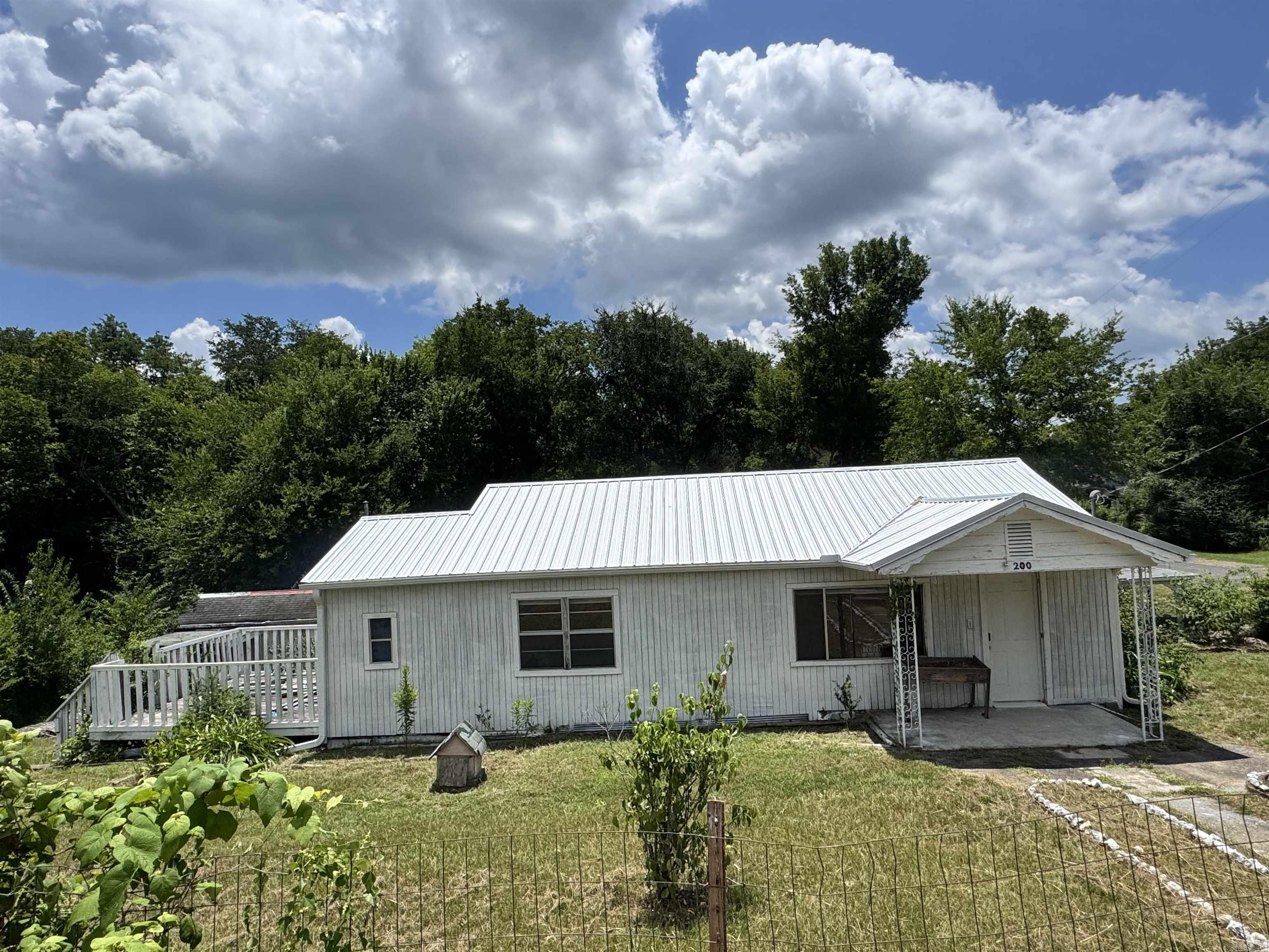 Value-priced home offering updated flooring, metal roof, large fenced backyard, and spacious rooms. Some cosmetic improvements are still needed, making this a great opportunity to build equity.