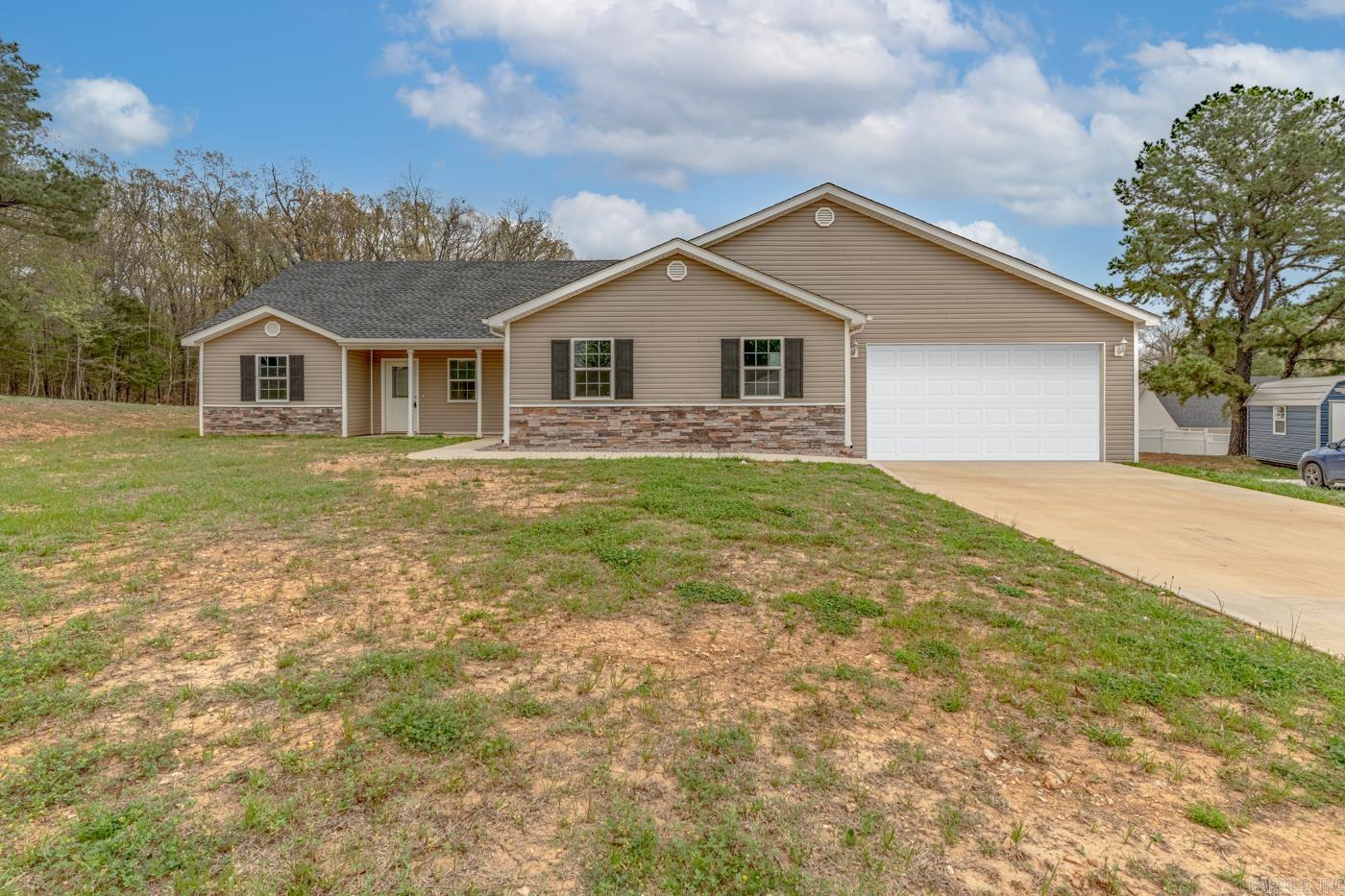 Welcome to Market 2516 Rebecca Dr. of the Cozy Country Estates Sub. in Pocahontas! Situated on a .32 +/- acre level lot is a 2024 Newly Constructed and Move-In-Ready Cozy Country property. The exterior is wrapped in stone & vinyl and accented by shutters, gutters, a 2 car attached garage, and patio out back. The interior features 1,935 SQF of living space that includes an open concept living/kitchen/dining area that holds a soaring ceiling, eat-in kitchen with quartz topped island, stainless steel appliances, ample cabinet & countertop space, and access to the patio. Unique in it's design, the living quarters hold a primary bedroom with tray ceiling and an en-suite with dual vanity and shower tub combo, a deluxe guest/in-law suite featuring a living area, bedroom, kitchenette, and en-suite with walk-in shower, 2 spare bedrooms and spare bathroom with shower tub combo. You'll love the vaulted ceiling, luxury vinyl flooring, and contemporary color palette. Conveniently located in the Pocahontas School district and just 45 minutes to Jonesboro and Paragould. Call today to schedule a tour and make this 2024 construction house your home!