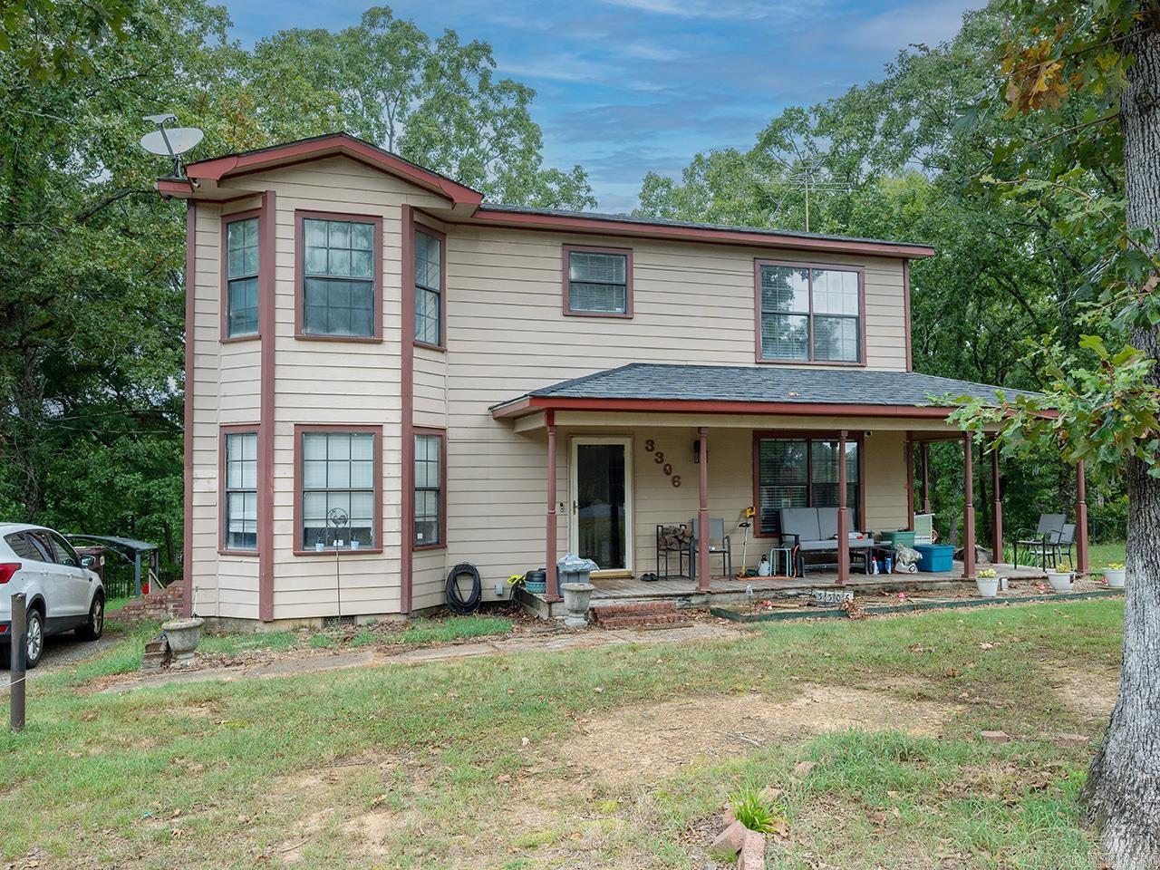 Escape to the perfect blend of peaceful country living and everyday convenience! Situated on .91 acres, this charming two-story home offers 4 bedrooms, 2 full baths, and 1 half bath with all bedrooms located on the same level. Inside, you'll find an inviting open floor plan featuring a spacious eat-in kitchen with a breakfast bar, dining area, and a versatile office/study or den. Recent updates include new flooring and a remodeled bathroom, adding modern touches throughout. Cozy up by the wood-burning fireplace or enjoy the comfort of central heat and air. Outside, the fully fenced yard provides plenty of room to roam and includes a covered porch, outdoor storage area, and a small shop—perfect for hobbies, projects, or extra storage. With paved road access, public water, septic, and a location that feels private while remaining close to town, this property is ready for its next owner. Don't miss your chance to enjoy space, comfort, and convenience all in one place!