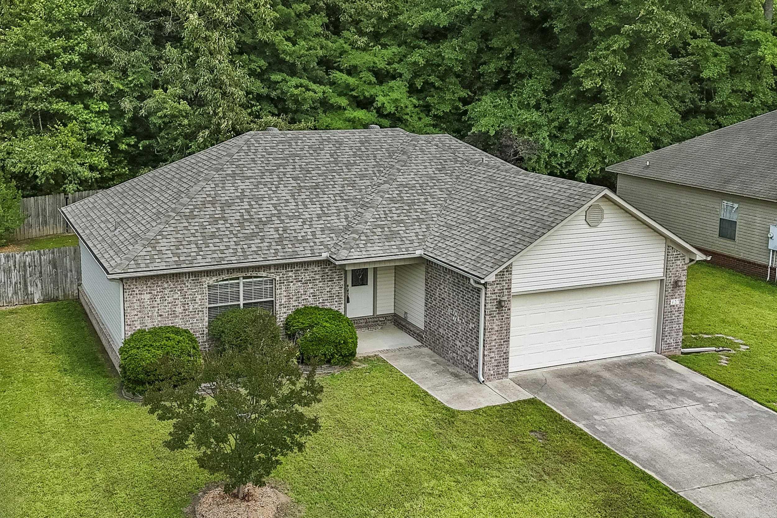This one is just like a new construction home! It is neat, clean, and way more than move in ready! Great location in the heart of Cabot. Take an easy walk to Cabot's Community Pond to get some exercise on the lit walking trail, do a little fishing in the stocked pond or maybe some disc golf on the 18 hole course. There is even a dog park for your pup and pavilions with a grill! Playground equipment for the kids. The home has a fantastic split bedroom plan. The spacious living room is loaded with trim, has a double tray ceiling plus an electric log fireplace. The kitchen sparkles with stainless steel appliances, white cabinetry, and the fridge stays! Master bedroom has a tray ceiling detail. Master bath features twin sink vanity, jetted tub, a stand up shower, and walkin closet. Very private backyard with woods behind you!  Enjoy time on your covered back patio. Roof replaced in 2022. 2" blinds all through the home. Gutters with leaf screens around entire home. This house is the bomb! There is a floor plan is documents section.
