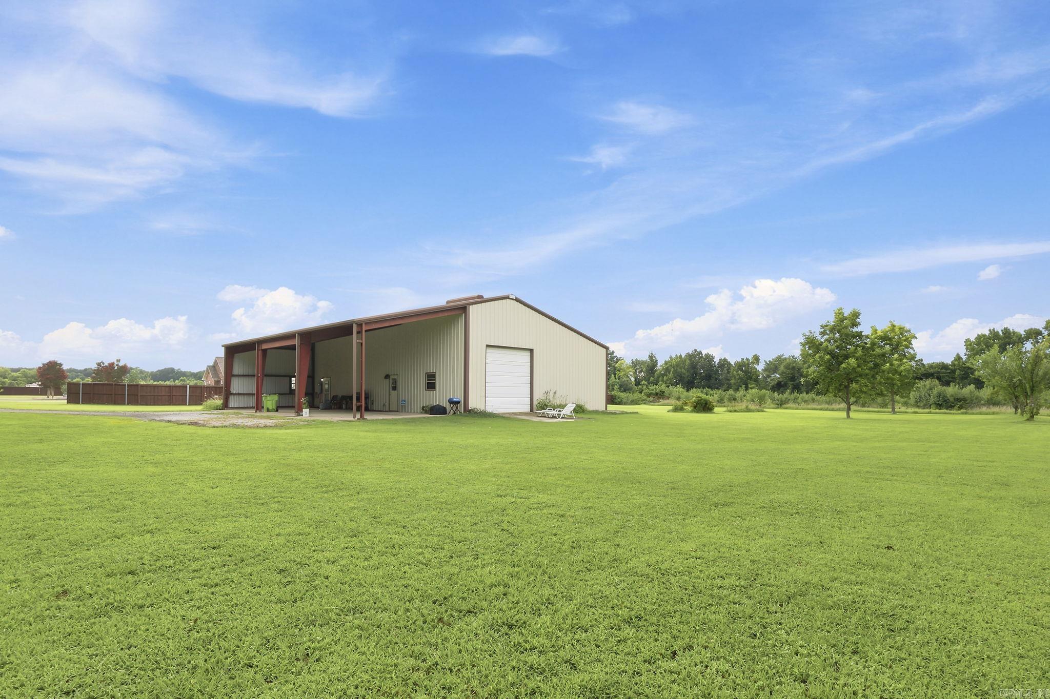 Rare opportunity in Lonoke! This versatile 4,800 sq. ft. shop on 5 acres offers multiple income and lifestyle possibilities. Zoned Commercial, the property features two separate living spaces inside the shop. The ground-level apartment offers 800 sq. ft. with 1 bedroom, 1 bath, an open living/dining/kitchen layout with island, plus a large laundry room with abundant storage. Upstairs, you'll find a spacious 500 sq. ft. efficiency apartment with full kitchen, bath, and large storage room. Together, the apartments currently generate $1,800 per month in rental income. The shop itself provides ample workspace with a third bathroom and utility sink, making it ideal for a business, contractor, hobbyist, equipment storage, or warehouse use. Live in one apartment while renting the other, lease both for investment income, operate your business onsite, or create the ultimate work-live setup. The 5-acre tract provides room for expansion, equipment, parking, outdoor storage, or future development opportunities. Whether you're an investor seeking cash flow, an entrepreneur needing workspace, or a buyer looking to offset expenses. No seller financing. Let's negotiate a deal today!
