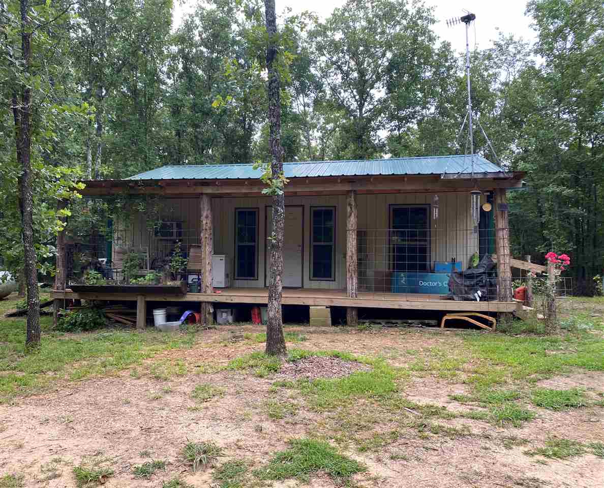 TIRED OF THE CRAZINESS AND CHAOS of the city, then this is the place for you. Talk about God's country; head to this woodland oasis. The stunning drive and rolling roads will melt the tension away as it leads it to your serene happy place. You can hear the sounds of nature on your front porch. 25 wooded acres, with a creek that runs through the property to your private pond. ALL furnishes convey.  Just bring your clothes and corn for the deer. The owners are leaving everything...storage bldg., fruit trees.