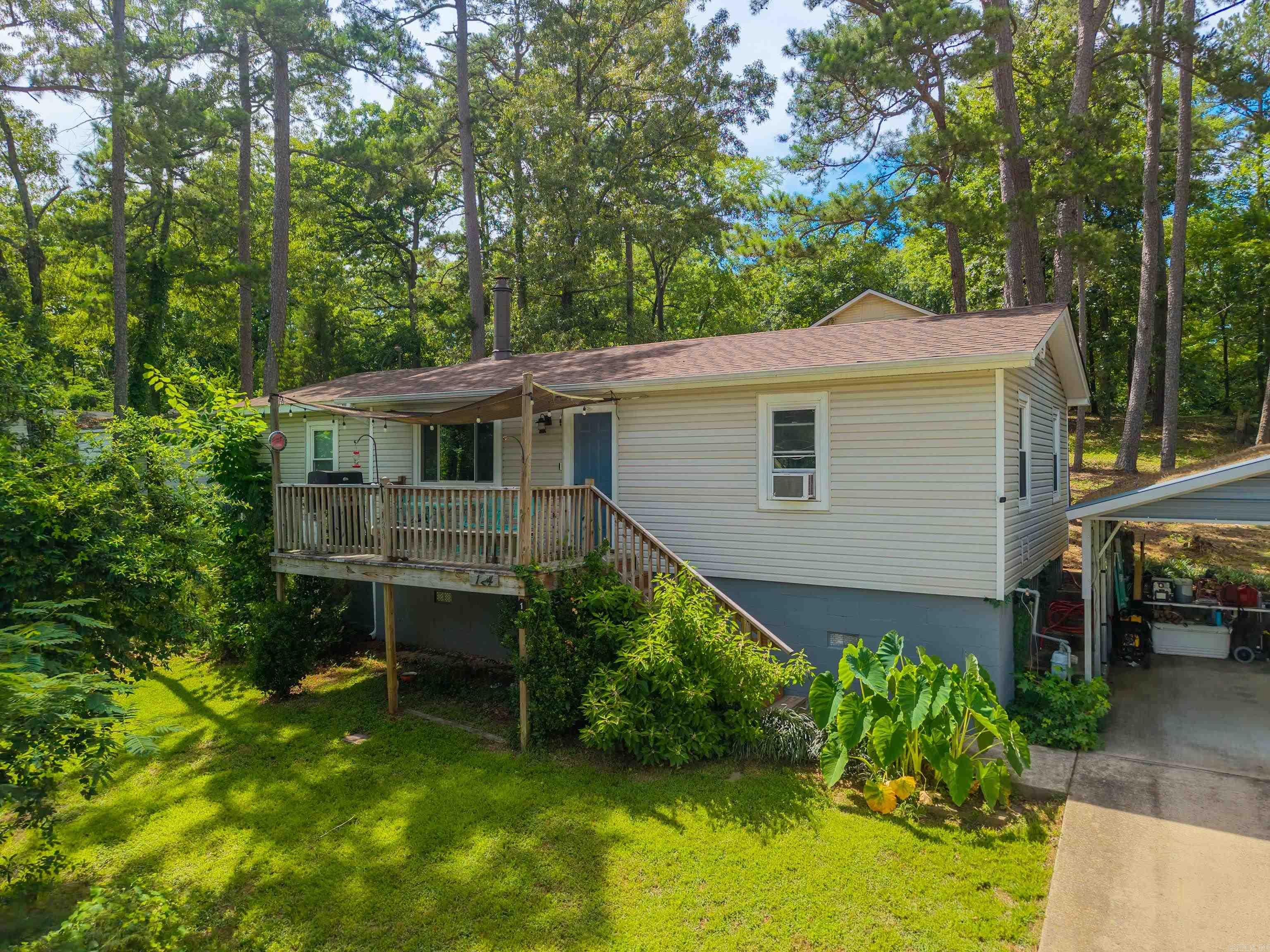 Country charm! Quiet neighborhood with a view of Lake Hamilton from your front porch, available access to community boat ramp. Nice size lot with tall trees that provide a good shade. Comfort and cozy three bed, two bath with a wood burning fireplace. Back yard has a nice patio area, room for pets or garden, concrete drive with carport. A second caport for storage with a small storage building for workshop or hobby. Plenty of parking for all your lake toys! New roof 2023, window units and gas wall heaters. Great for first time home buyers or an excellent weekend getaway. This would be a great rental investment property to add to your portfolio.  Lake Hamilton Schools.