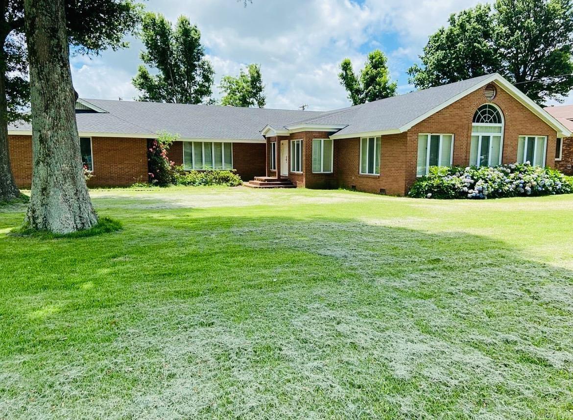 If you're looking for a home that truly has it all, this one is the perfect fit! Recent updates include a brand new roof (2025) with a 30-year warranty and a new HVAC system to be installed prior to closing. This spacious 3,560 sq. ft. home sits on a 0.67 acre lot. Inside, you'll find beautiful plantation shutters all  through out the home along with abundant windows that fill the home with natural light. The layout features three bedrooms, including two master suites with large private bathrooms, plus three walk-in closets, one of which is cedar lined. The home offers massive built-in storage, a large living room, and a formal dining room perfect for entertaining. A cozy den with a wood-burning fireplace provides a relaxing space to unwind. Bathrooms include two walk-in showers (one recently updated) and a Jacuzzi tub. The kitchen is equipped with dual cooktops with ventilation hoods, a dishwasher, refrigerator, and deep freezer. The spacious laundry room includes ample storage and a new washing machine. Flooring throughout the home includes a mix of hardwood, marble, and carpet. Outside, a 400 sq. ft. detached workshop provides additional space for projects or storage.