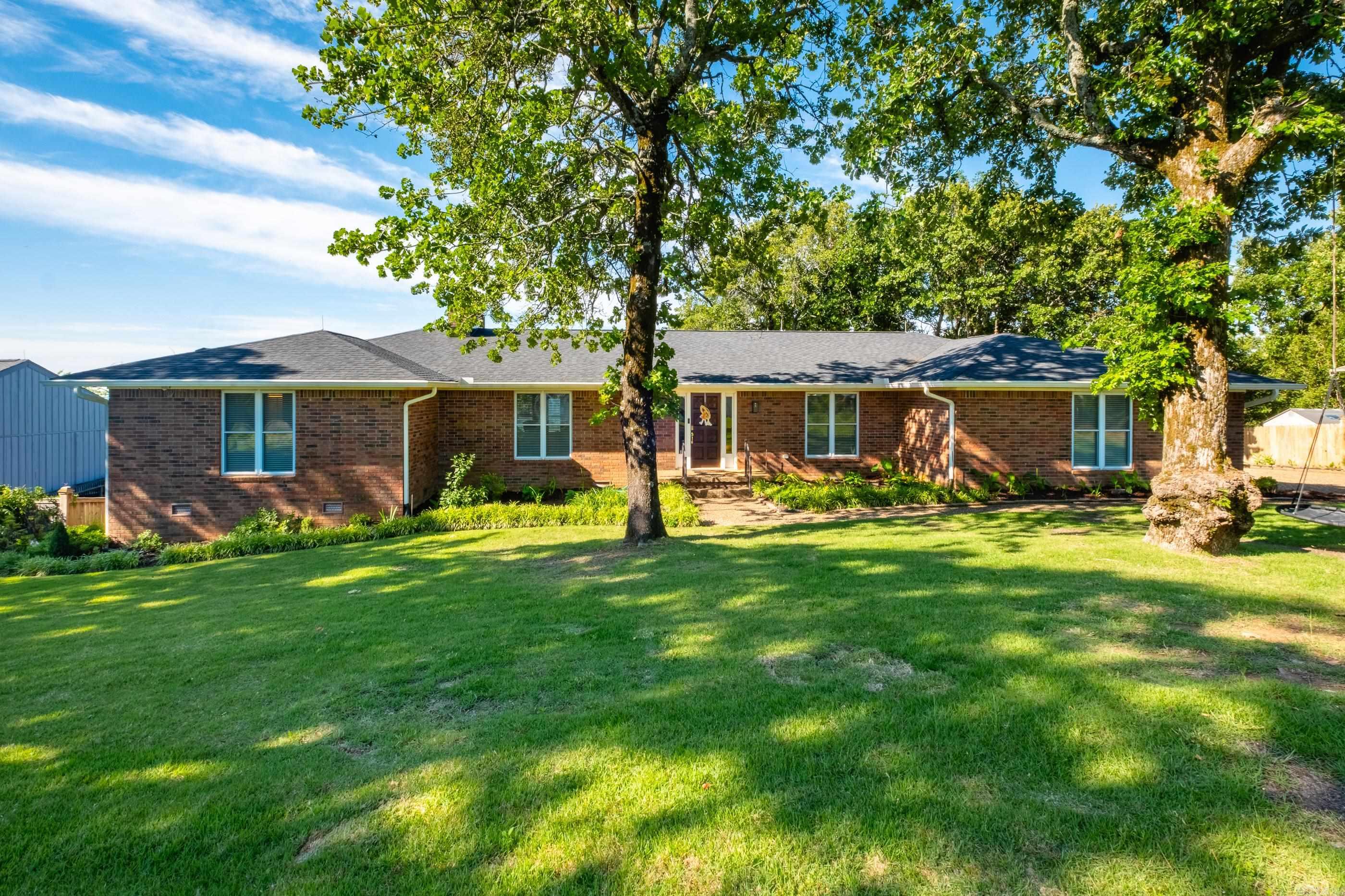 Welcome to this beautifully updated home in the Walton Heights, where stunning valley views stretch for miles. Featuring 4 bedrooms, each with its own updated private bath, plus an additional half bath.  The thoughtfully designed layout includes a spacious primary suite and guest bedroom on the main level, while upstairs and downstairs living spaces provide room for everyone to spread out. A game room, office and an additional flex space, currently used as a gym, offer endless possibilities for entertainment, hobbies, or work-from-home needs.  The gourmet kitchen is designed for both cooking and gathering, complete with double ovens, a 5-burner gas cooktop, and abundant space to entertain. Additional updates include a new roof, a lower deck, 2 water heaters, and a storage building.  Step outside to a backyard built for fun and adventure, featuring a treehouse, zipline, and playset, along with extensive parking.  Located just minutes from Cantrell Road, I-430, shopping, and great restaurants, Walton Heights also offers access to miles of well-maintained hiking and mountain biking trails that lead all the way to the Arkansas River.