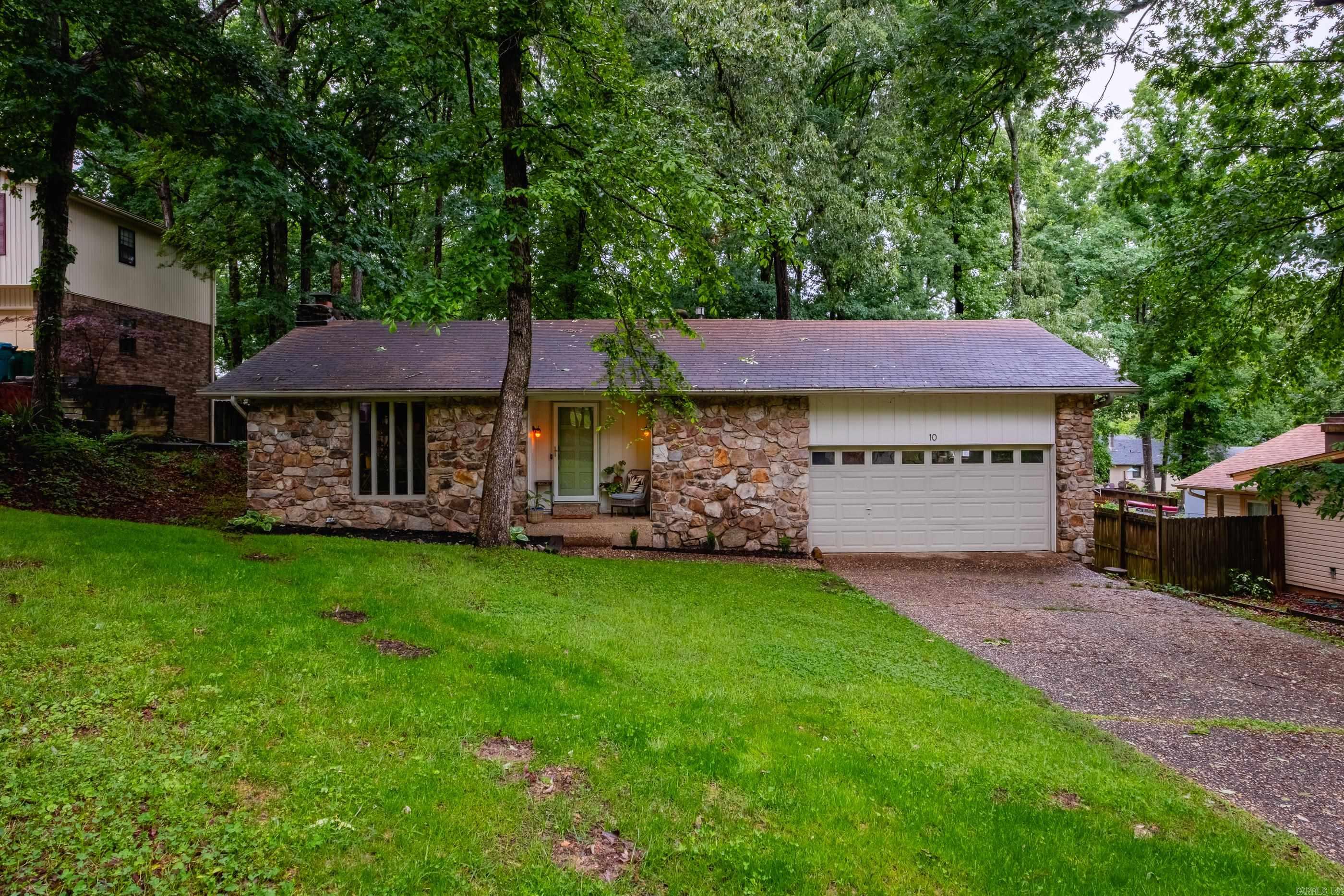 Great new home tucked away on a quiet cul-de-sac - This three bedroom, two full bath home is move in ready and full of charm. Large living room with a gorgeous stone fireplace, vaulted ceiling and wood beams that bring all the character. Newly updated kitchen and bathrooms, all new flooring, new interior and exterior paint. Huge laundry room plus a great deck overlooking a massive fully fenced backyard with beautiful trees. This home feels good the minute you walk in. New water line from main to the house and new sewer line. Neighborhood pool opening this summer! Agent See Remarks.