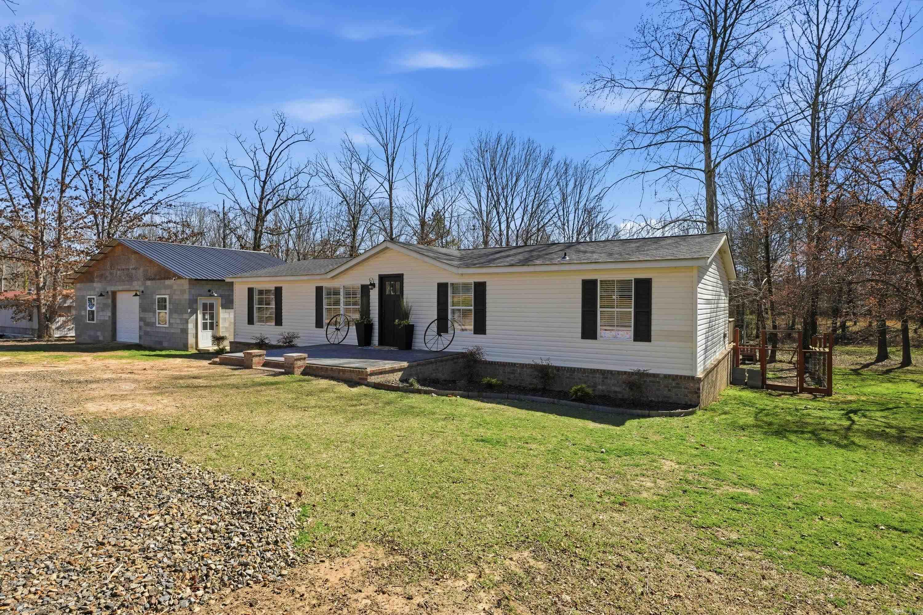 This isn't your typical remodel. Taken all the way down to the studs, this home (on a permanent foundation) has been completely rebuilt with thoughtful updates throughout. You'll love the custom kitchen, beautiful tiled showers, accent walls, mini-split units, and the fact that just about everything is new. Outside, you'll find a fully fenced yard, brick skirting, a 24x36 shop with plenty of storage, plus an attached, finished 12x24 room that's perfect for a home office, craft room, gym, or small business. Situated on 2.4 acres in Houston/Bigelow, you're less than 10 minutes from West Conway and Walmart, giving you the peace of country living with the convenience of town nearby. An additional homesite with its own septic system and utilities is already in place, making it a great opportunity for a second home, rental property, workshop, or multi-generational living. Move-in ready with endless possibilities!