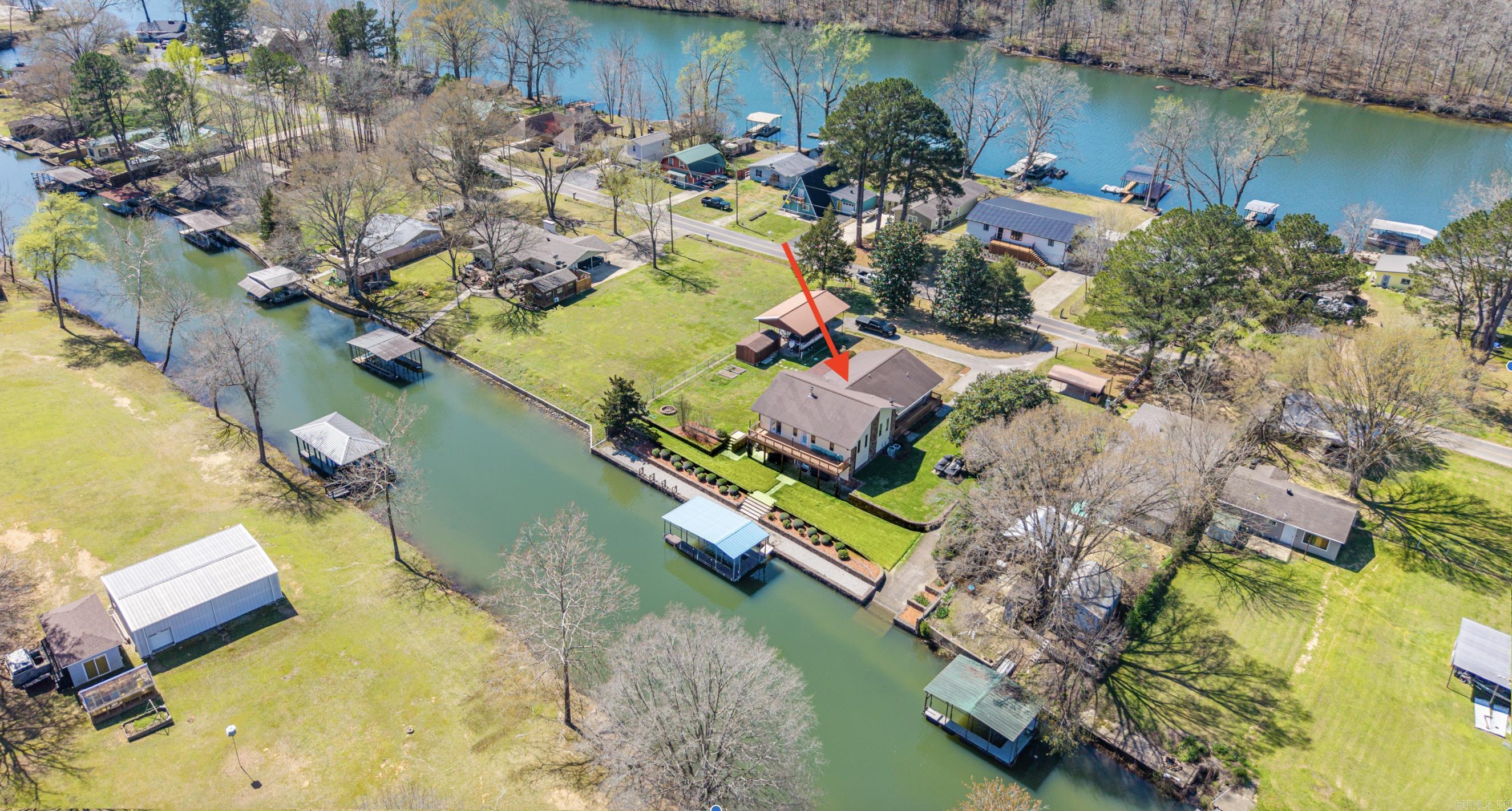 Must see! Modern-country lake living at its best! Beautifully Remodeled Lakefront home in Lake Hamilton situated on a rare flat lot with easy water access.  Enjoy your own Private Boat Ramp, Covered Boat Dock, Seawall, and RV parking with hookup for effortless lake days.  Inside features an inviting open-concept kitchen and living area designed for entertaining. The home offers Two Primary Suites and a large office with built-in stove and wood-burning fireplace.   Expansive patios and decks extend the living space outdoors, providing the perfect backdrop for entertaining, relaxing, and enjoying the peaceful waterfront setting.  Turnkey waterfront property ready to enjoy cool and refreshing lake days! See Agent Remarks