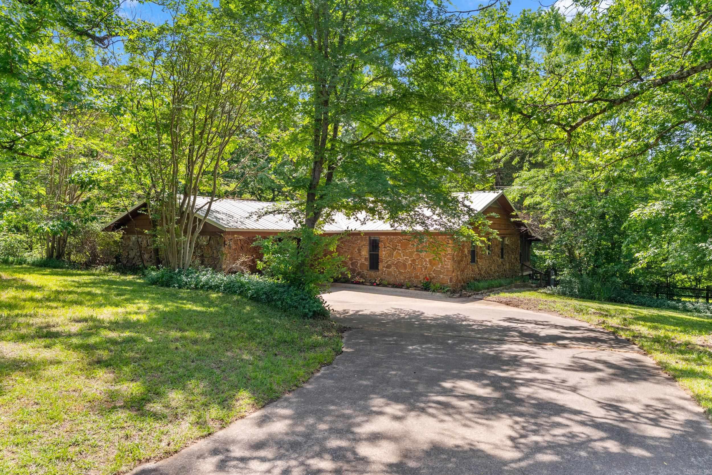 This property offers a rare opportunity to own 116 beautiful acres in the highly desired Greenbrier school district, just minutes from Conway. This incredible property is a dream for an outdoor enthusiasts, featuring abundant wildife, excellent hunting and recreational opportunities, and over 2800 feet of frontage along the East Fork Cadron Creek. With some marketable timber, horse and cattle potentional and endless possibilities for a multigenerational homestead or private retreat, this property turly has it all. The charming home features original hardwood floors in great condition and the third bedroom is used as an office. There are options. The stunning rock and stone used in construction were sourced from the property, adding character and history you won't find anywhere else. Whether you're looking for a getaway, working farm, recreational paradise or a forever estate, this one of a kind property is unmatched and offers privacy and potential. Old survey available and Minerals convey!!!