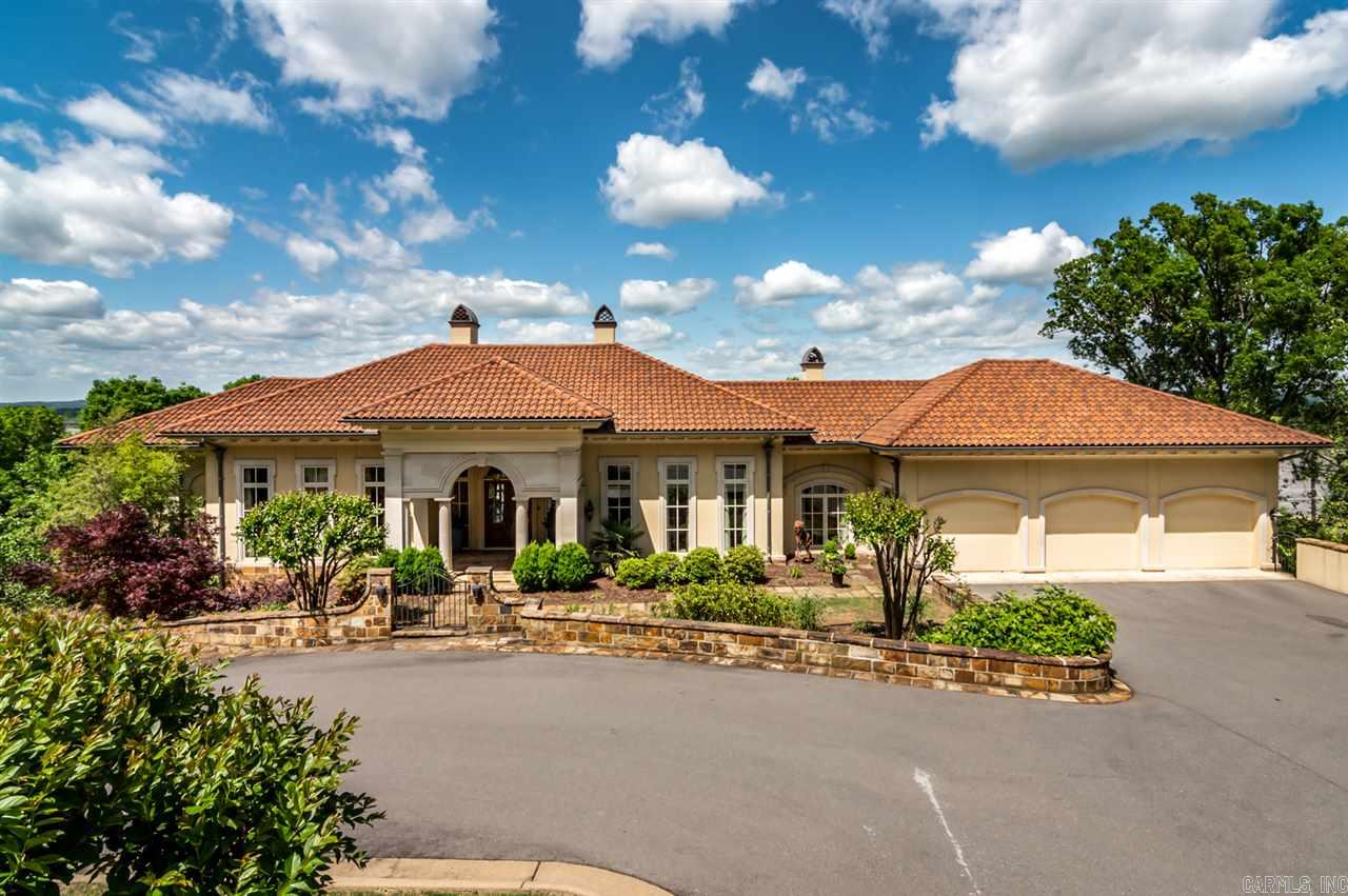 Some of the most stunning views of the Arkansas River and Big Dam Bridge can be seen from this beautiful custom home.  Well appointed kitchen is just steps away from the cozy hearth room with 1 of 4 fireplaces.  Large Master Bedroom with access to large covered patio has separate his and hers master baths.  Lower level includes 3 guest suites, den, office and HUGE game room/bonus room.  Plenty of parking with 3 car garage and additional garage on lower level for parking or storage.