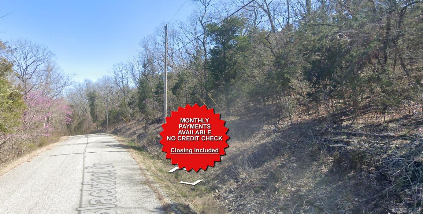 County appraised value $7500. Owner-finance available for easy terms. You cannot camp or park a trailer on the lot. No mobile homes but other types of housing is allowed. Not far from Eureka Springs, the Missouri and Oklahoma border and very scenic mountain area. Public sewer and water at the paved road and electric not far. Nice lot to develop or hold for future value. Owner/agent. Finance is $250 down and $295 a month for 10 months. Quit claim deed conveys. Closing costs are included. Bulk land sales specialist with the best land prices in Arkansas. Over 10 years, as a licensed Realtor, selling land.  Parcel ID# 320-03947-000