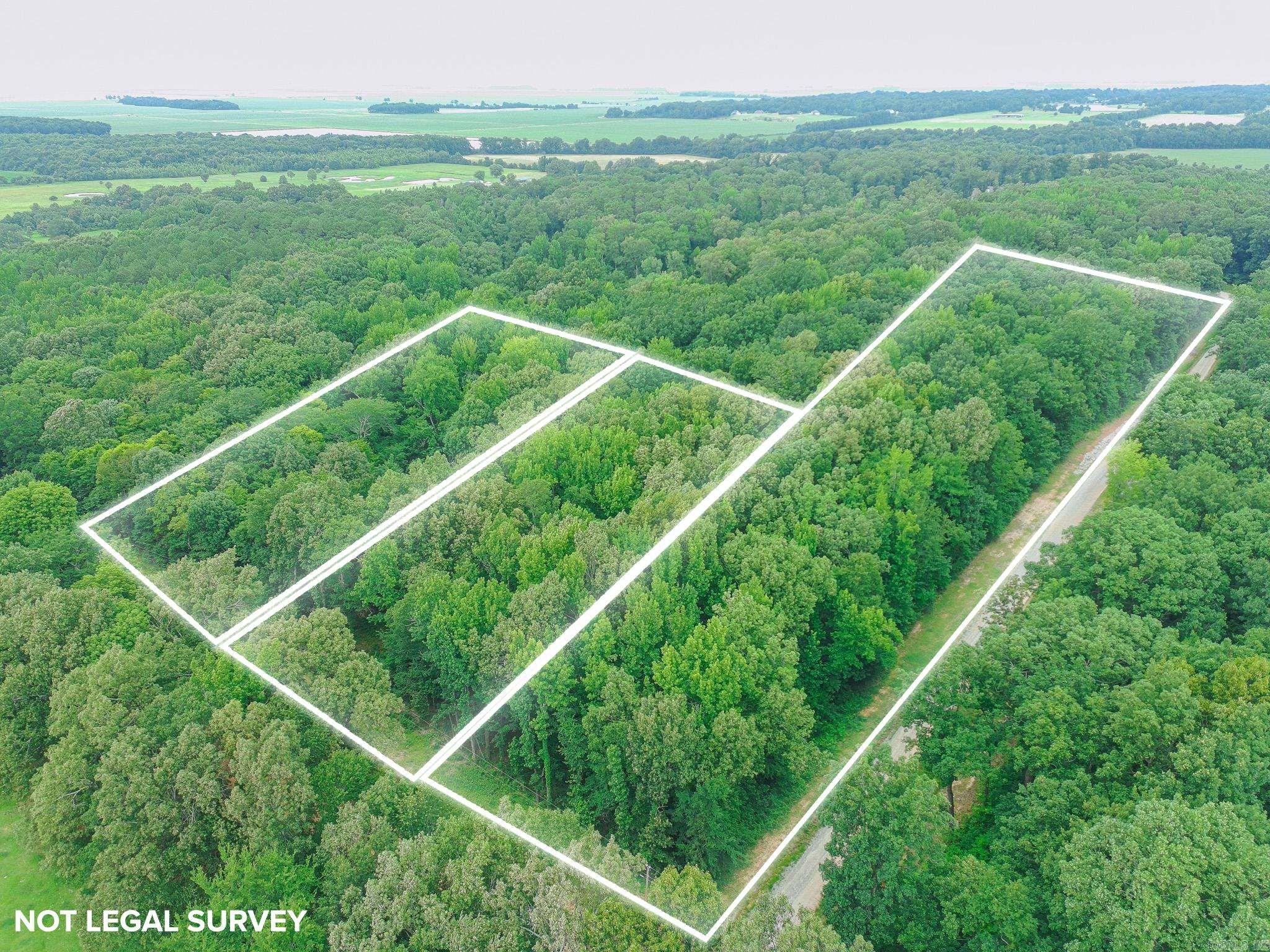 Beautiful wooded lot with large trees and a perfect building spot in the center of land.
