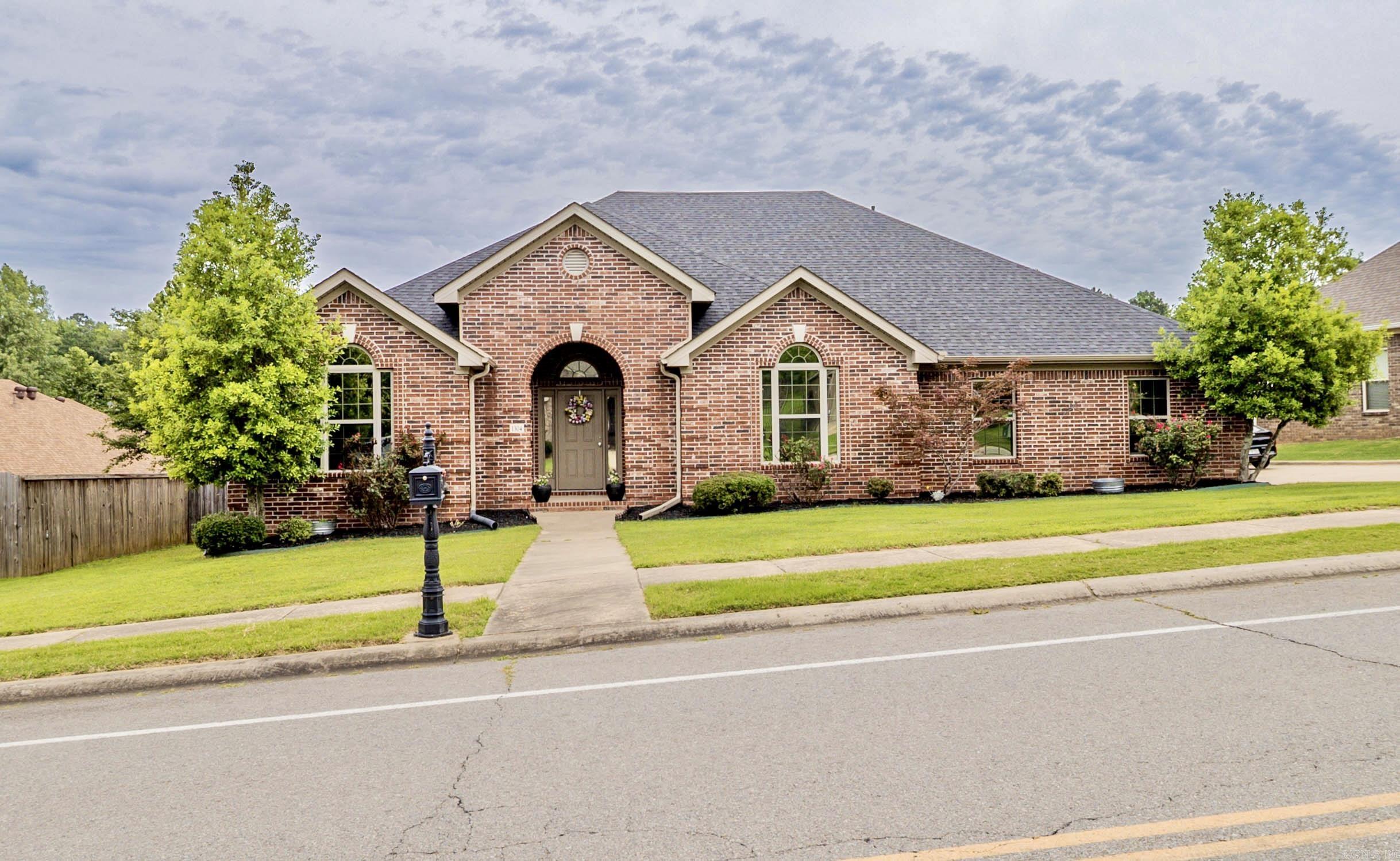 Welcome home to this beautifully maintained 4-bedroom, 2-bath home in one of Benton's desirable established neighborhoods. Offering 2,200 square feet of living space, this home features a functional split-bedroom floor plan designed for both comfort and privacy.  Recent updates include new carpet in all bedrooms and fresh neutral paint, giving the home a clean, modern feel that's truly move-in ready. The spacious living area features a cozy gas-log fireplace and flows seamlessly into the kitchen and dining spaces, making it perfect for both everyday living and entertaining.  The kitchen offers granite countertops, abundant cabinetry, and plenty of workspace for the home chef. The oversized primary suite provides a relaxing retreat with a whirlpool tub, separate shower, dual vanities, and a large walk-in closet.  Outside, you'll find a large yard and inviting curb appeal in a convenient location close to schools, shopping, dining, and everything Benton has to offer.  Don't miss your opportunity to own this spacious home with room for everyone!
