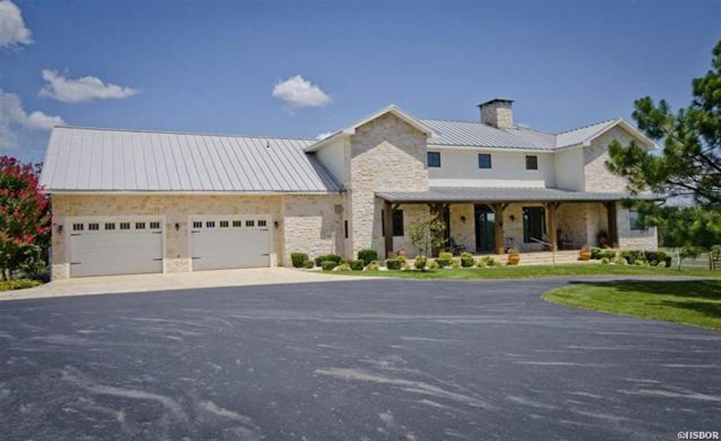 Modern Country Home 4,505 +/- Estate on over 23 Acres MOL. The 4 Bedroom/2.5 Bath home was built in 2007 with modern high quality finishes. Some features include: Hardwood Flooring, Arched Doorways, Cathedral Ceilings accented with Solid Wood Beams, Two Story High Living Room Fireplace. Large Veranda across the back of the home gives gorgeous views of rolling pasture and mountains. This property is Cross Fenced and Gated with Two Ponds. Oversized Double Garage & 2,200 +/- Barn.