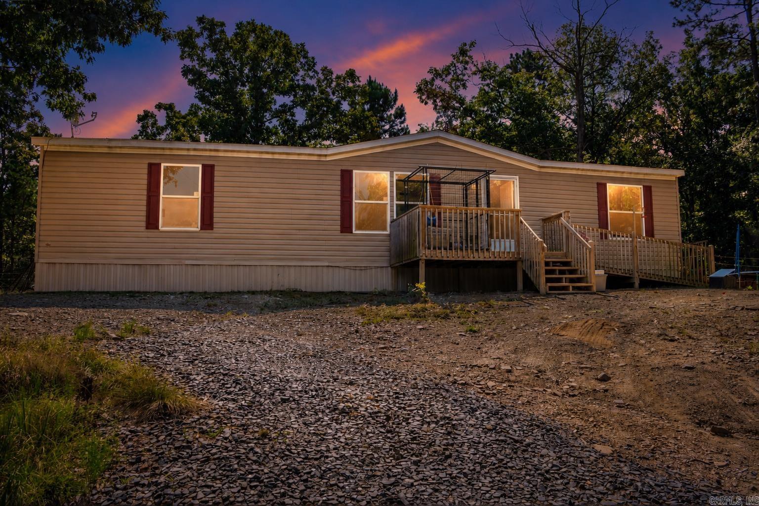 Picture yourself coming home to 536 Polk Road 72 Mena, AR, where modern comfort meets the privacy and freedom of 3.5 wooded acres. Built in 2023, this 3-bedroom, 2-bath home offers 1,560 square feet with an open layout that makes everyday living feel easy. Imagine gathering around the kitchen island, enjoying meals in the dining area, or settling into the spacious living room for movie nights. The kitchen features abundant cabinetry, stainless appliances, and generous workspace, while the split-bedroom design gives the primary suite a sense of separation. Walk-in closets, a walk-in shower, dedicated laundry space, and central heating and air add practical comfort. Step outside onto the deck and take in the trees, cleared ground, and room to create the lifestyle you have been picturing, whether that means a garden, workshop, outdoor entertaining area, or simply more space to breathe. Set on a permanent foundation with well and septic, this property delivers the country setting buyers want without sacrificing the features they need. Your next chapter does not have to feel crowded. It can begin right here.