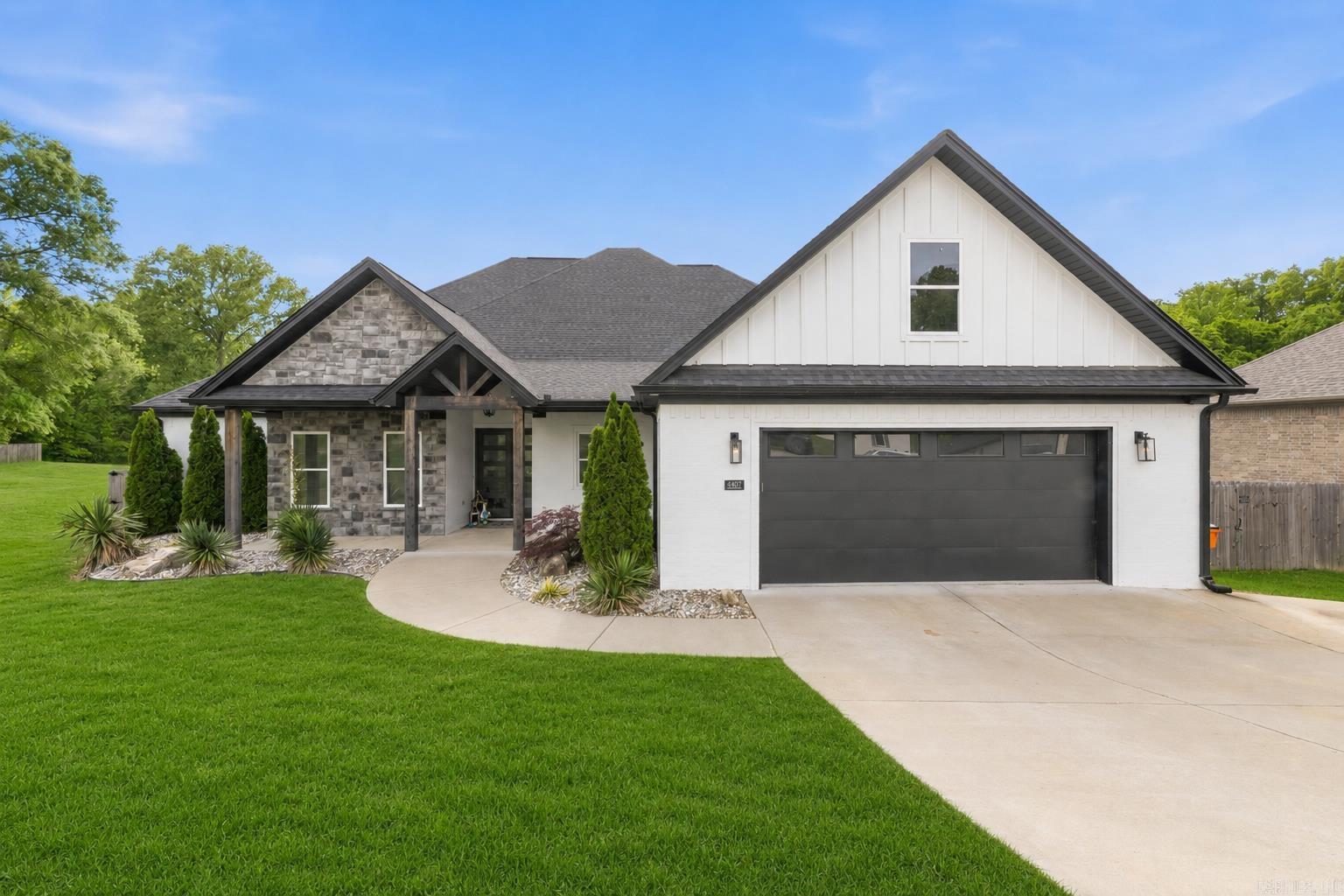 Step into refined living with this beautifully designed home set on 1.21 acres, where luxury meets functionality. Flooded with natural light, the open-concept layout features wood-look tile in the main living areas, wet areas, and primary suite, anchored by a stunning living room with soaring vaulted ceilings. Kitchen has an 11-ft island with built-in storage, soft-close cabinetry and drawers, plus dedicated spice and utensil storage, perfect for both entertaining and everyday living. Just off the main space, a dedicated office or potential 5th bedroom offers privacy and versatility. Retreat to the primary suite, complete with a spa-inspired bathroom featuring a luxurious pass-through shower, a striking stone wall behind the soaking tub, and a custom closet with built-in dressers and vanity. Guest bedrooms each offer walk-in closets for extra comfort. Additional highlights include an oversized garage with dual storage closets, a huge laundry and mud room, and abundant storage throughout. Enjoy peaceful outdoor living on the large vaulted back porch with a fireplace, overlooking gorgeous green space and direct creek access. Extra parking pad to the right just added for convenience!