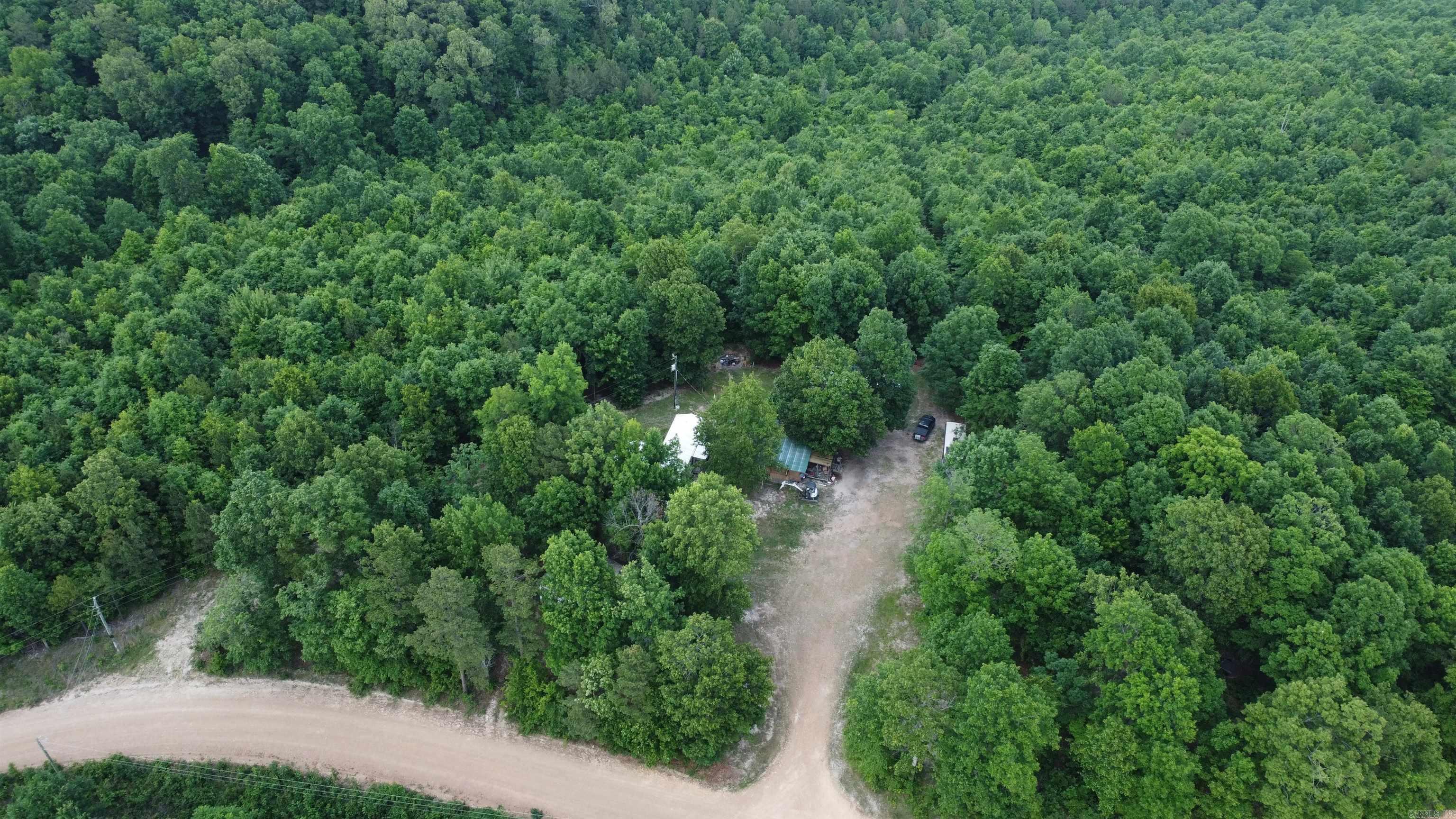 Cabin on 26 Acres Near Loafer’s Glory WMA – Harriet, AR  Escape to the Ozarks with this unique opportunity in Harriet! Situated on 26 beautiful acres, this 24x24 cabin offers the perfect setup for a hunting retreat, weekend getaway, or future homestead project. The cabin is a fixer-upper with tons of potential and already features a durable metal roof, plus water and electric are already connected — giving you a solid head start. The cabin sits on about an acre of partially cleared land, surrounded by wooded acreage with ATV trails running throughout the property, making it easy to explore and enjoy the outdoors. With county road access, the property is convenient to reach while still offering privacy and seclusion. Outdoor enthusiasts will love the location — approximately 2 miles from Loafer's Glory Wildlife Management Area, providing quick access to public hunting, hiking, and recreational opportunities. Whether you're looking for a hunting camp, off-grid-style escape with utilities already in place