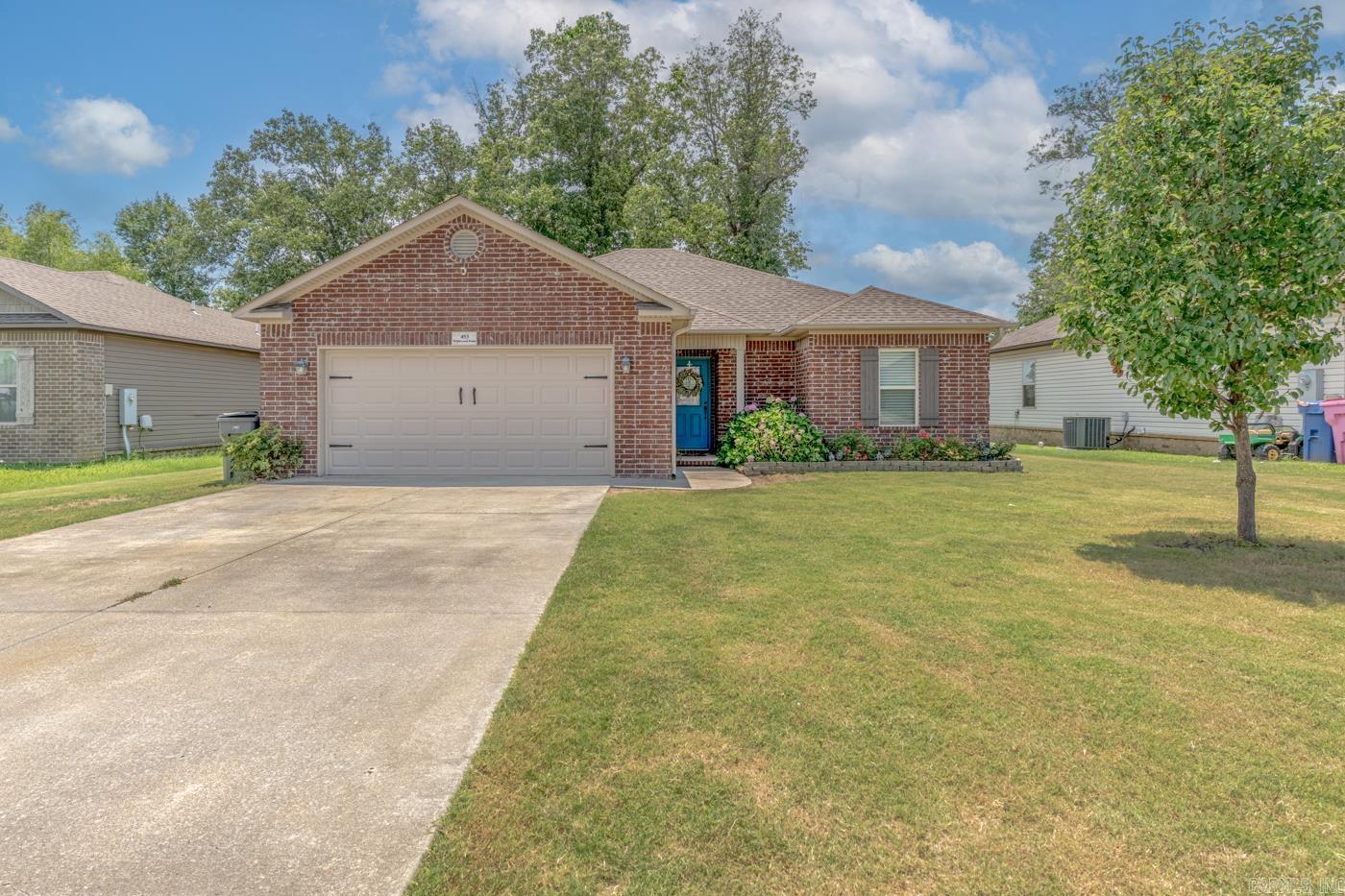 Welcome to Market 453 Wildwood Point in Jonesboro, AR within the Nettleton School District. Built in 2018, this move-in ready, all-electric 3 bedroom, 2 bath home offers 1,430 sq ft of well-laid-out living space over a split & open floor plan situated on a .18± acre privacy fenced lot with tree-lined views. Wrapped in brick & vinyl, topped with architectural shingles, and accented by a covered front porch, shutters, guttering, two-car garage, and beautiful landscaping. You'll love the stained concrete floors, vaulted ceilings, and electric fireplace. The kitchen features a tile backsplash, stainless appliances, and pantry. The primary suite offers a double vanity, soaking tub with tiled shower surround, and walk-in closets. Two additional bedrooms, a full bath with a shower/tub combination, and a dedicated laundry room complete the interior. Step outside to enjoy the spacious privacy fenced backyard complete with a wood deck. Additional features include floored attic storage, a security system, and fiber internet. Conveniently located just minutes from shopping, dining, NEA Baptist Hospital, Arkansas State University, and Highway 49 North. Call today to make this house your home.