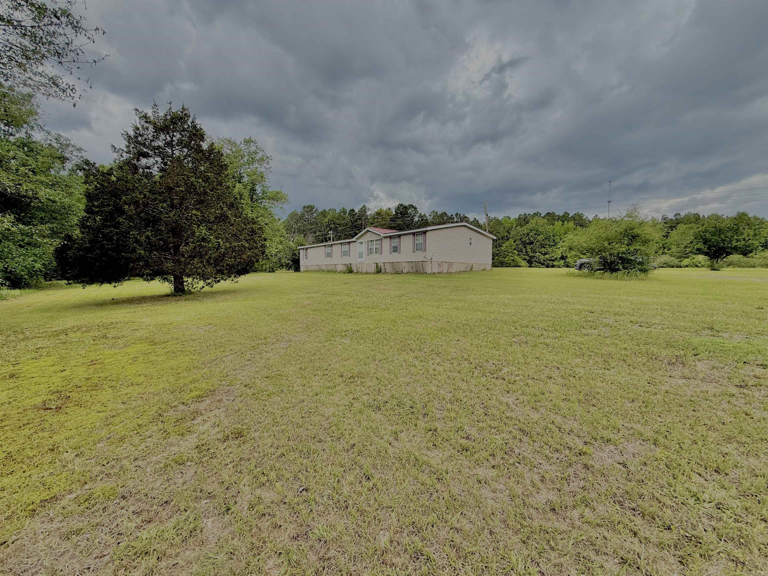 Fixer upper with room to grow! Sitting on 9.5 acres, this 2010 double wide offers space, potential, and the opportunity to create your dream homestead without breaking the budget. Featuring 5 bedrooms and 3 baths, this home has a spacious layout with an open dining and kitchen area, large living room, and generously sized bedrooms throughout. The primary suite includes a long walk-in closet and walk-in shower. Whether you’re looking to start a small farm, need room for animals, or simply want peaceful country living with space inside and out, this property is packed with possibilities!