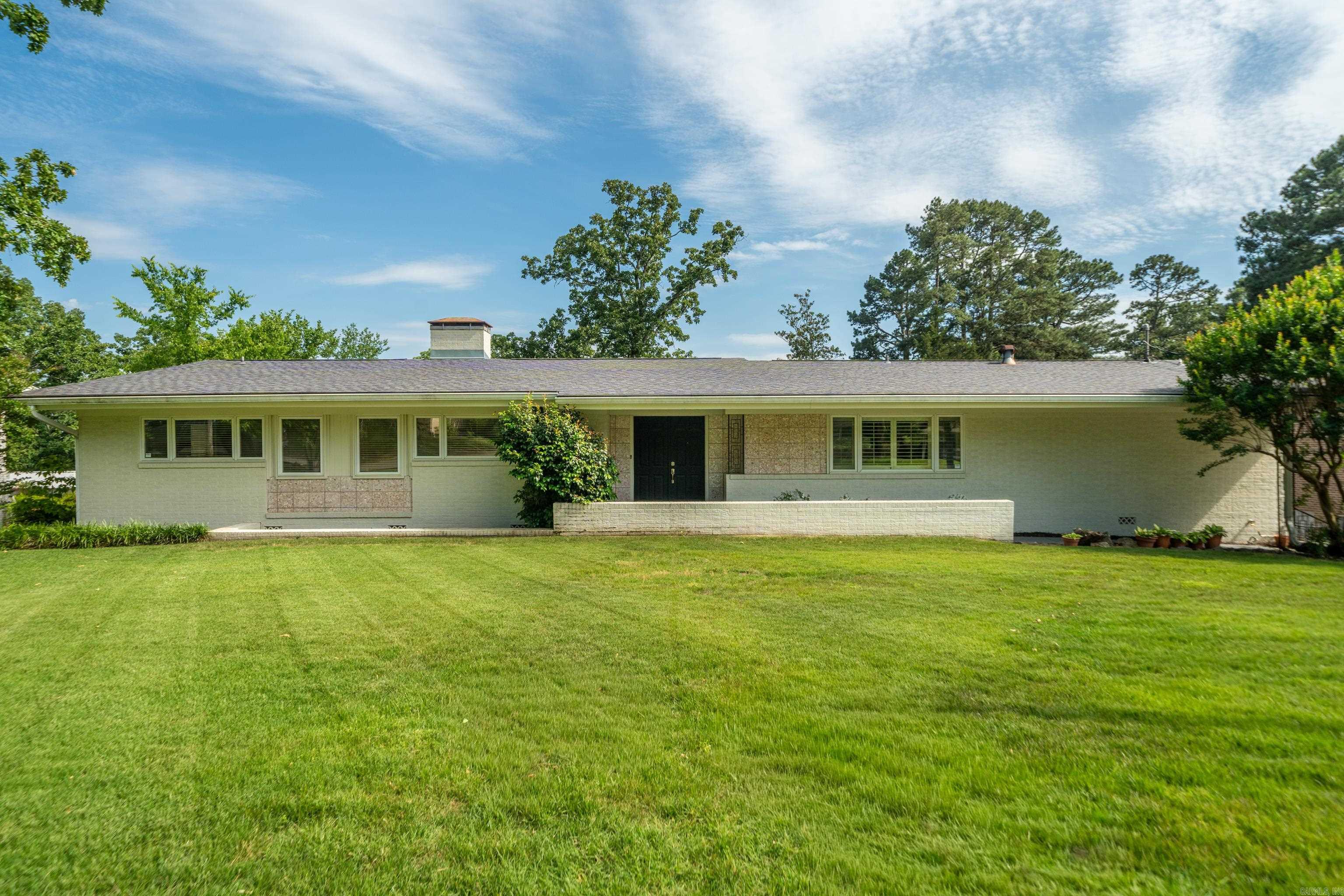 Welcome to this stylish mid-century modern home offering plenty of room to live, work, and entertain! The spacious kitchen provides ample prep space, storage, and room for gatherings both large and small. Featuring 4 bedrooms, 2 full bathrooms, and 2 half bathrooms, this home offers a flexible layout to fit a variety of needs. The lower-level den includes a wet bar and fireplace, creating the perfect setting for game nights, movie marathons, or relaxing evenings at home. Situated on nearly a half-acre lot, the property also includes additional storage space and a greenhouse ready for gardening, hobbies, or year-round plant care. With character, functionality, and unique features throughout, this home is ready for its next chapter!