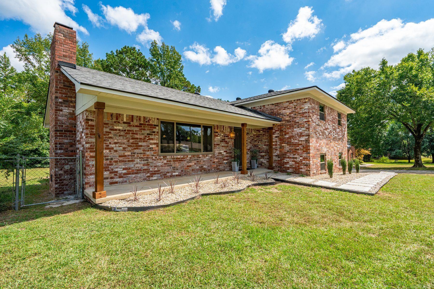 Situated at the end of a quiet, dead-end street, this beautifully renovated brick home offers a desirable open floor plan and modern aesthetic. A wood-burning fireplace clad in large-format tile creates a dramatic focal point for the living space. New cabinetry, quartz countertops, luxury vinyl plank flooring, custom tilework, and designer lighting carry the premium feel across the home. With 4 beds/3 full baths—including two private en-suites, ideal for guests, or multigenerational living. Major updates include a new roof, HVAC, water heater, appliances, and insulated windows, which provide lasting peace of mind. Outside, the generously sized level lot, oversized double garage, expansive new deck with sleek wire railing, and fully fenced backyard offer the perfect combination for play, pets, and gardening. The owners—who are also the listing agents—personally curated every finish, delivering a cohesive design that is both stylish and comfortable. (Bonus: This property sits outside the city limits and is not part of a subdivision, allowing you the freedom of living without POA fees or restrictions.