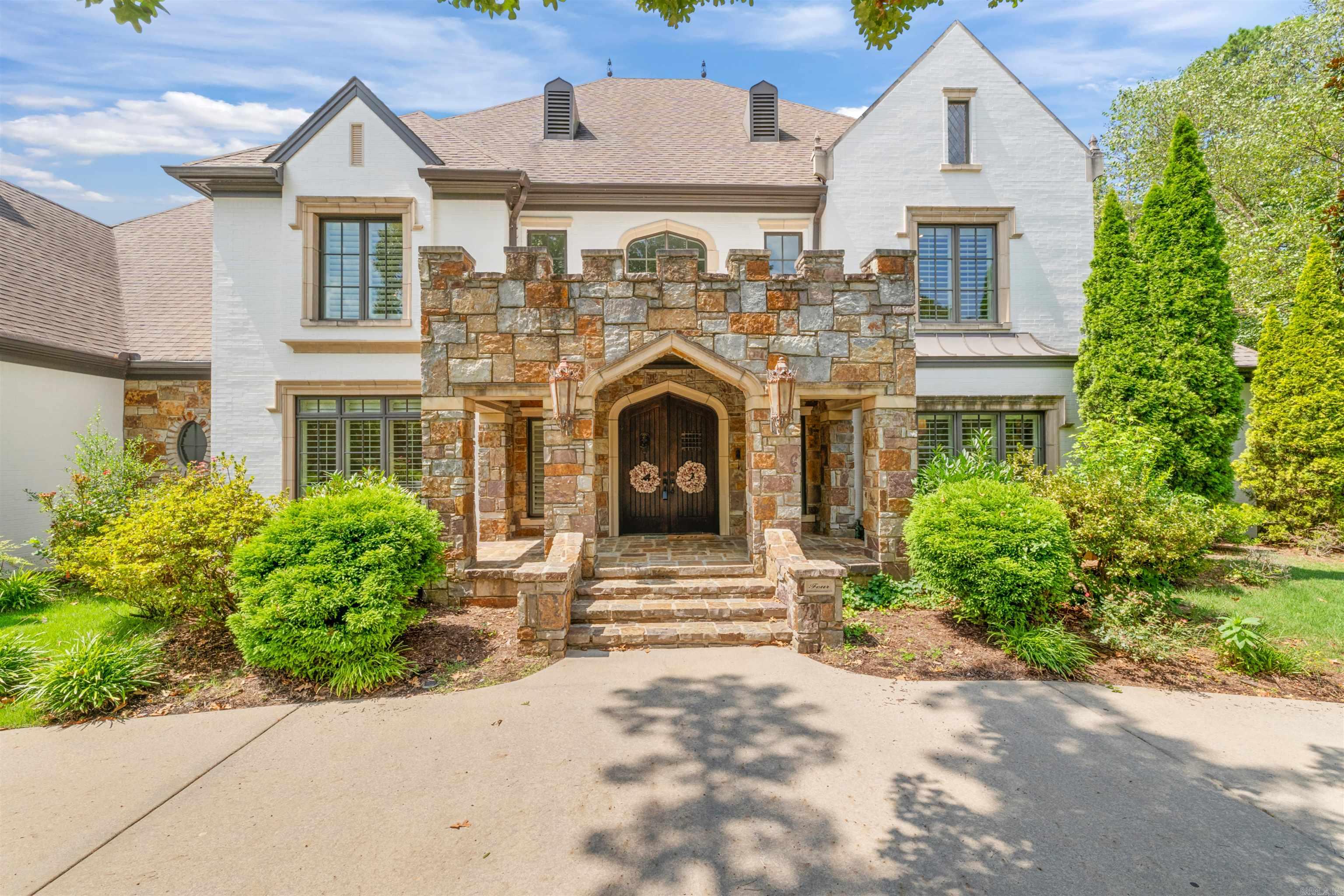 Designed for both elegant entertaining and everyday living, this home offers generous space and timeless appeal. The main level features a chef’s kitchen with gas cooktop, double ovens, two dishwashers, microwave, large island, walk-in pantry, and coveted Sonic ice machine. Multiple living areas include a formal dining room, private office, hearth room, and formal living space, along with a luxurious primary suite on the main level. Upstairs offers four bedrooms, three full baths, two versatile bonus rooms, and extensive walk-out attic storage. Outdoor living shines with a sparkling pool, hot tub, play set, and lush greenspace providing exceptional privacy. A three-car side-loading garage with new doors and oversized storage completes the property. Located in the heart of Chenal, just minutes from top schools, golf, dining, and outdoor recreation—this is Little Rock luxury living at its best.