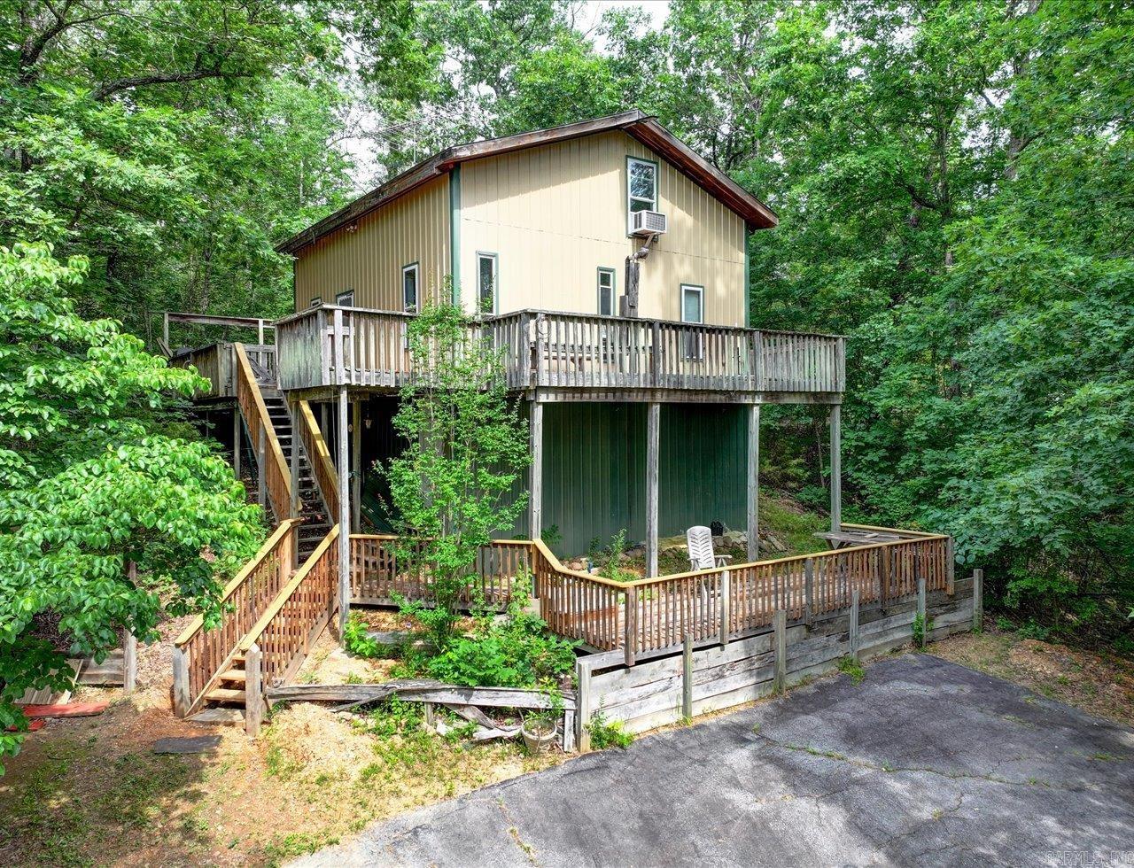 Scenic Ouachita River Property 9.25 Acres with Two Homes  Versatile 9.25-acre property with views of and access to the Ouachita River, offering exceptional flexibility. Ideal for a primary residence, rental income, homesteading, multi-generational living, or future development, this property combines space, privacy, and opportunity.  The main home (built in 2004) offers approximately 1,128 sq ft with a durable metal exterior, 3 bedrooms, and 1.5 baths. An elevated structure provides space for storage or storm shelter, and a spacious deck offers scenic views. The home is accessible from River Drive and Black Cherry Lane.  The second home (circa 1900) offers approximately 1,572 sq ft, 2 bedrooms, and 1 bath. Rich in character, it requires TLC and presents excellent potential for restoration or rental use.  Multiple outbuildings include a 20x22 carport, 14x20 garage, 20x20 pole shed, and 20x30 pole shed, providing ample storage and workspace. The property is partially fenced and suitable for gardening, livestock, or additional home sites. A new survey has been completed.  Private Ouachita River property offering space, versatility, and river access. Also see MLS 25004832