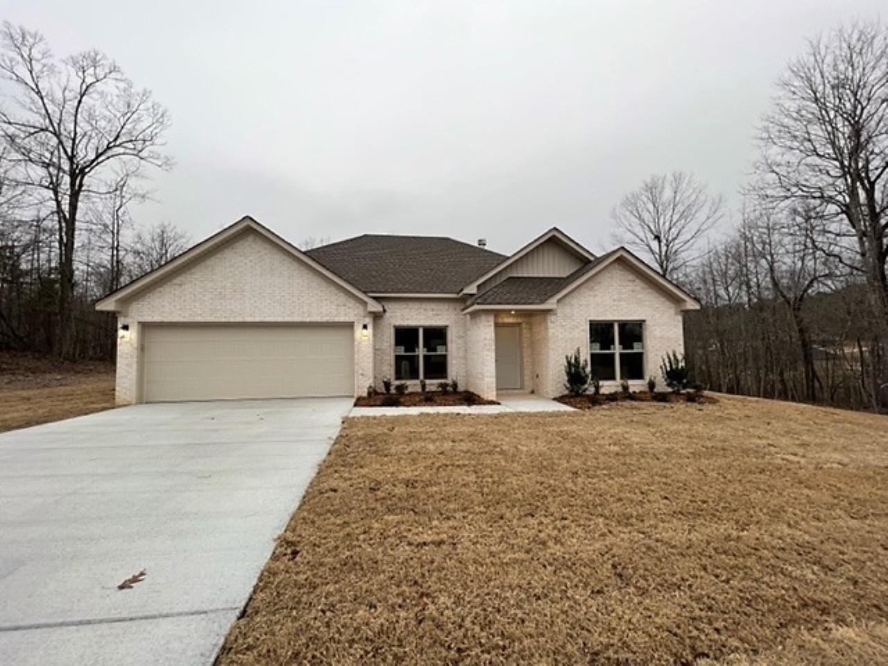 New Construction in Pinewood Estates. Living area has 10' ceiling , w/b fireplace & is open to kitchen. Kitchen has custom cabinets w/ez-close drawers, granite counter-tops & s/s appliances. Crown molding in all rooms. Hardwood floors in LR, kitchen, dining, & hall. Ceramic tile floors in baths & laundry. Carpet in BRs. Split floor plan. Master BR has tray ceiling. Master bath has sep. shower, soaker tub, & large closet. Laundry room w/storage. Approx 0.87 acre lot. Bryant Schools.  Agents see Remarks