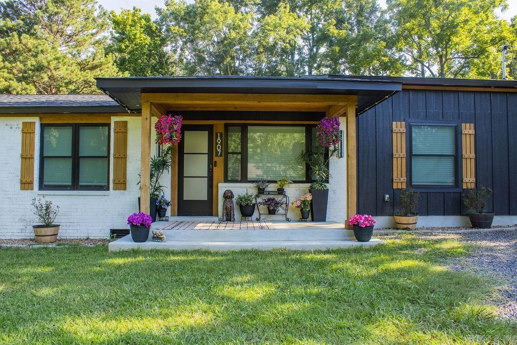 Picture yourself pulling into 1907 Wertz Avenue and realizing you do not have to choose between style, space, and possibility, you can have all three. This home was completely gutted to the studs and rebuilt with quality finishes, thoughtful craftsmanship, and a warm modern design that feels right the moment you walk in. As you move through the open living area, notice the striking fireplace wall, natural-wood accents, durable flooring, and a kitchen designed to bring people together with quartz countertops, stainless appliances, abundant cabinetry, and a large island. The spa-inspired bath features a double vanity, open shelving, and an oversized walk-in shower with black-framed glass. Outside, the rare double lot provides more than half an acre to relax, entertain, garden, or grow. Then imagine the possibilities inside the brand-new two-story shop, workspace, storage, guest quarters, a studio, home office, or future living space. With covered parking, a privacy-fenced backyard, and room to make it your own, this rare in-town property is ready to become the home you have imagined. This is more than a remodeled home. It is the place where your next chapter can begin.
