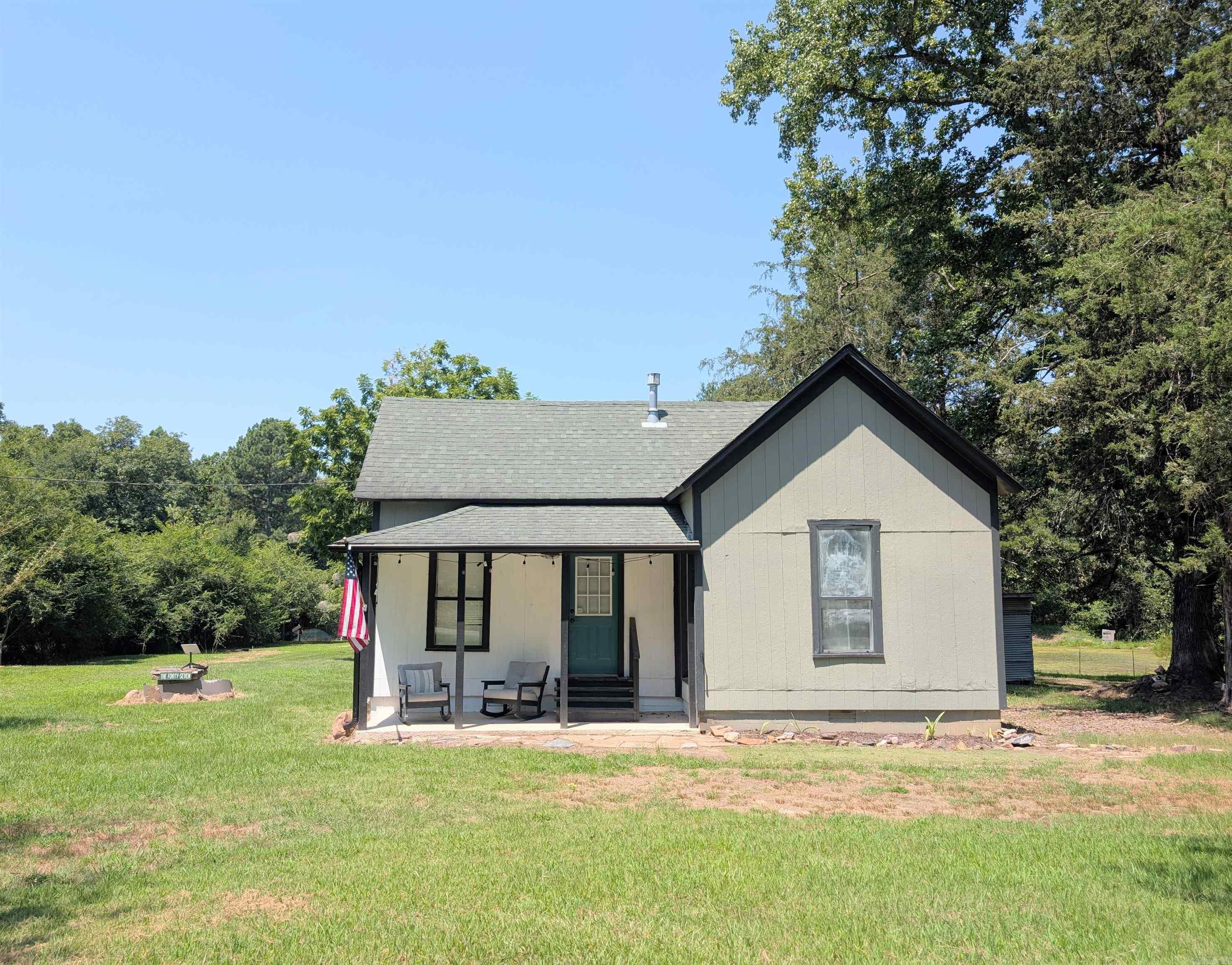 Country living with income potential! Nestled on 10 acres just outside of Mena, this 2-bedroom, 1-bath home offers a peaceful rural setting with a pond, seasonal creek, and open pasture ideal for livestock. The property also features a large shop currently operating as an income-producing dog boarding facility with 15 separate kennels, creating a unique opportunity for buyers seeking an established business or versatile commercial-quality improvements. After a long day, relax in the outdoor living area overlooking the pond and enjoy the quiet surroundings. With usable acreage, water features, fenced pasture, and an established kennel operation, this property offers a rare combination of country living and income-producing potential.