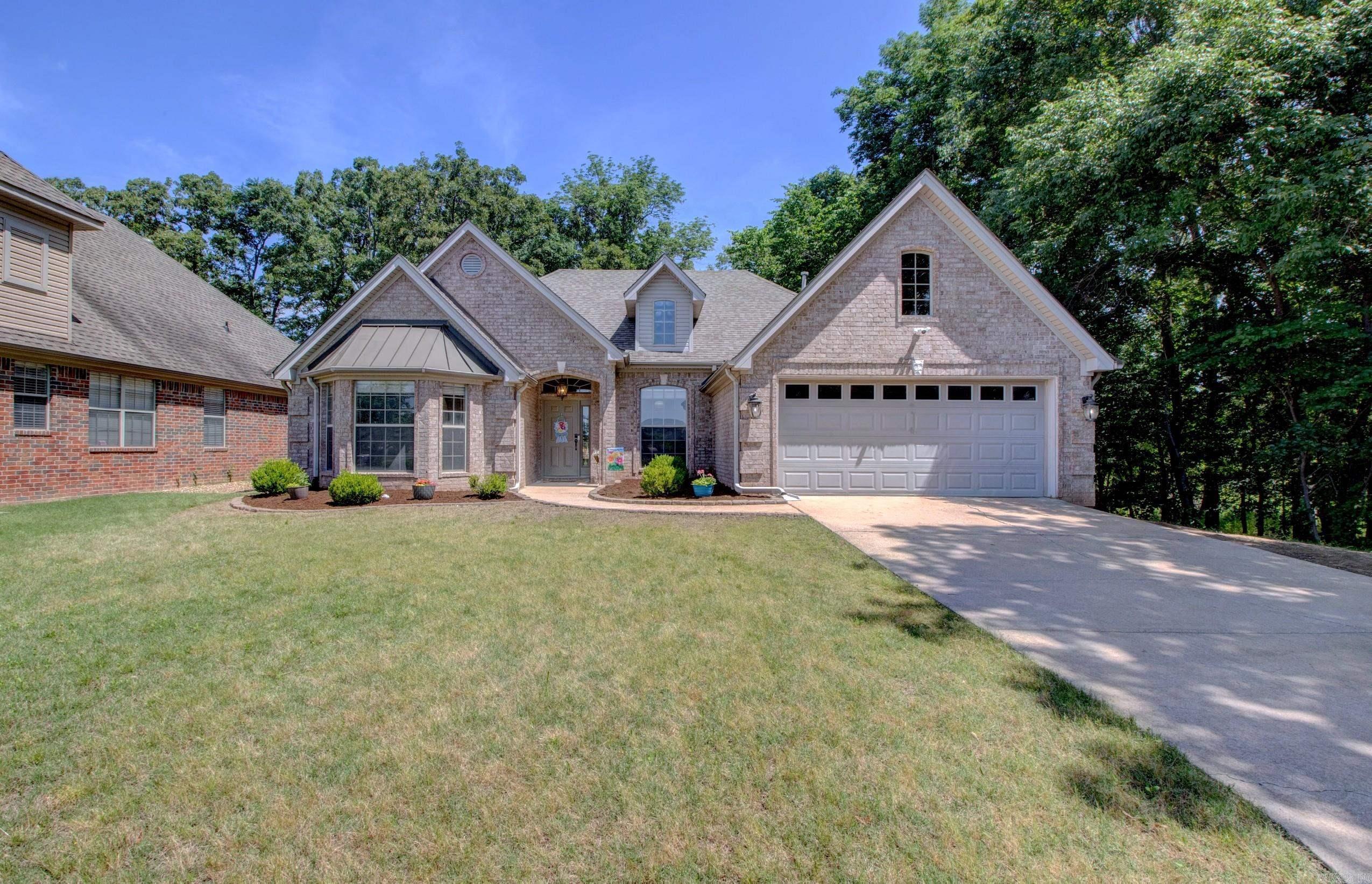 Show Stopping Drop Dead Gorgeous! Hurry over to see what the fuss is all about. Luxury living in the prestigious gated Sologne subdivision of The Country Club of Arkansas! This stunning custom-built one-level home offers 2,116 SF with 4 bedrooms, 2 bathrooms, and a desirable split floorplan. The spacious open-concept design is filled with natural light from abundant windows and features soaring 10–12 ft ceilings, tray ceilings, elegant crown molding, hardwood flooring throughout, cozy gas log fireplace. The custom kitchen includes updated appliances, pantry, gas range/oven, and refrigerator that conveys at closing. Formal dining area offers flexible space for office or second living area. The private primary suite features a soaking tub, walk-in shower, double vanities, and walk-in closet. Agents See Remarks.Enjoy peaceful views from the back patio overlooking protected wetlands, mature oak trees, walking trails, green space, and fishing lake. Roof 2017, HVAC 2018, Water Heater 2019. Private quiet cul-de-sac living in one of Maumelle’s most desirable golf course communities! Extra Boxes of Engineered Hand Scraped Harwood flooring to replace carpet in Primary Walkin Closet.