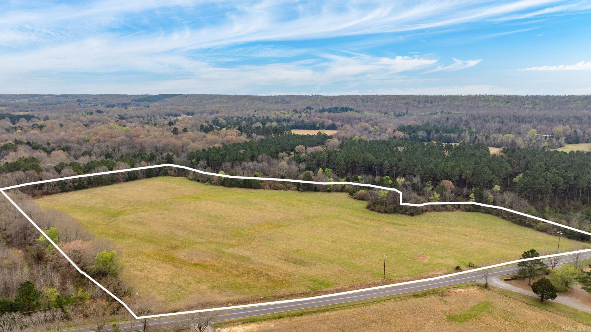 15.33 ACRES WITH A CREEK and SELLER PAID perc test with an accepted offer! Tucked away just under 8 miles from Conway, this 15.33-acre slice of Arkansas beauty feels like your own private retreat without sacrificing convenience. Mostly cleared and ready for your vision, the land stretches out with wide-open pasture potential while a peaceful creek winds along the back and side of the property, adding both charm and a natural boundary. A perimeter of mature trees offers the kind of seclusion that’s hard to find, creating a quiet, tucked-away setting perfect for building your dream home or establishing a working farm. Whether you’re picturing cattle grazing at sunset, a custom home for prime porch sittin', or simply a place to spread out and breathe, this property delivers the space and setting to make it happen. Opportunities like this don’t come around often this close to town; privacy, usability, and natural beauty all in one. Nearest grocery store is a 2-minute drive away. Survey on file. Be sure to watch the drone video on YouTube!