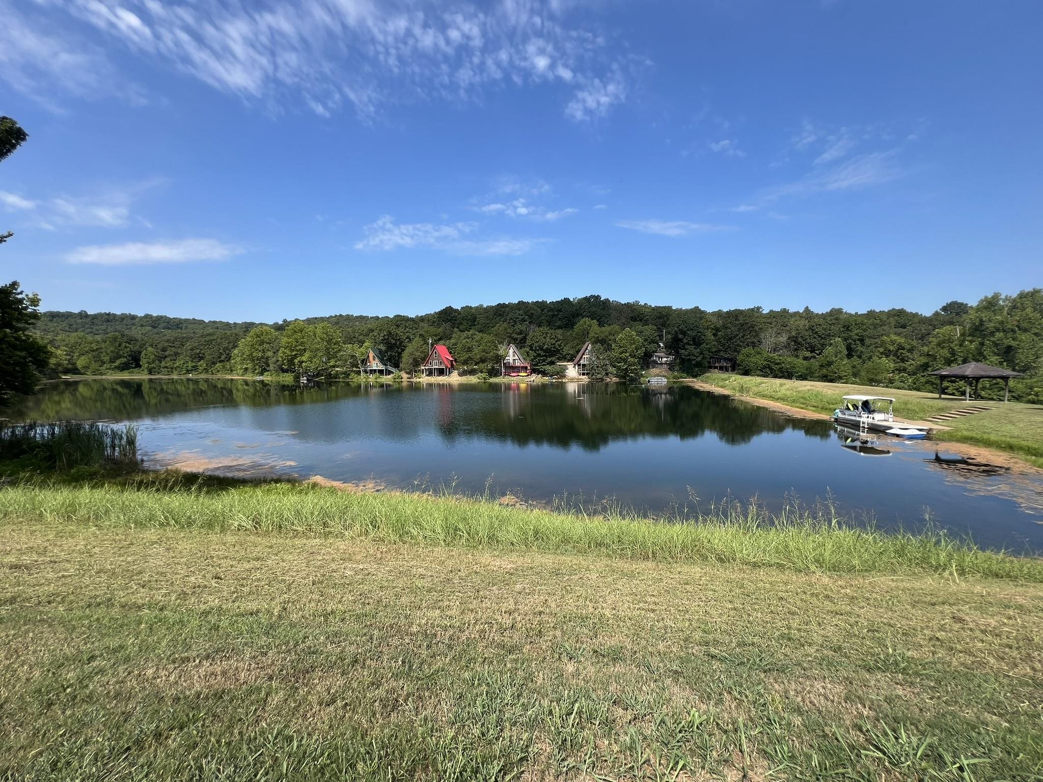 Recreational Property with frontage on Kiwanie Lake, formerly known as Lake Galilee. Potential RV Park/Air BnB cabins or build your dream home it is currently used as a private retreat. The 5.44 acres of land is serviced by Entergy Electric and 2 Highland water meters. There are 15 camper pads (10x20), 3 have 50 AMP service, 7 have 30 AMP service, 3 have septic risers and there is a dump station near the 2022 installed septic tank is 1000 gallons with a 5 line drain field and an RV dump station.  Sized it for a 3 bdrm/2 bath house.  Added 3 RV risers, and more can be added if wanted. . Two frost free hydrants, set such that they can serve multiple pads, 3 Pavilions and a pontoon boat utilized as a floating dock. Park area also has 2 fenced tennis courts and a 20x40 in ground pool in need of some maintenance to be operational. This property is near but not in Cherokee Village, it has a Hardy AR address but is not in the city limits.