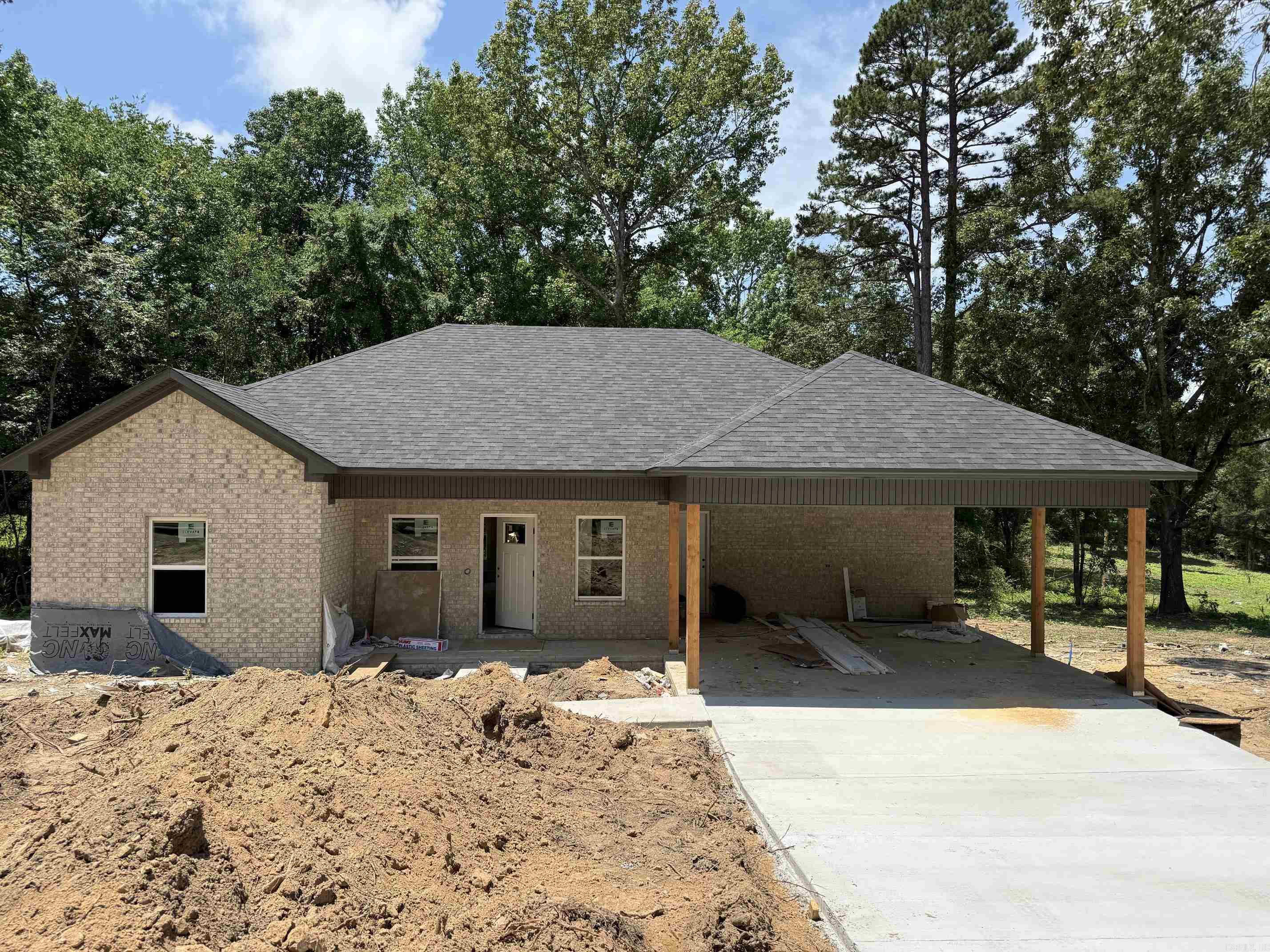 Welcome home to this beautifully crafted new construction brick home, nestled among mature trees on a spacious lot. This thoughtfully designed 3-bedroom, 2-bathroom residence offers the perfect blend of classic charm and modern living. Step inside to discover an open, light-filled living area with recessed lighting and fresh finishes throughout. The kitchen is a standout feature, boasting an oversized island, custom cabinetry, and ample counter space — perfect for entertaining and everyday living. Outside, enjoy a covered carport and a concrete driveway, with plenty of room to landscape and make this property your own. Surrounded by beautiful natural scenery, this home offers privacy and tranquility while remaining conveniently accessible to both Greenbrier and Conway. Completion expected soon — don't miss your chance to be the first to call this one home!