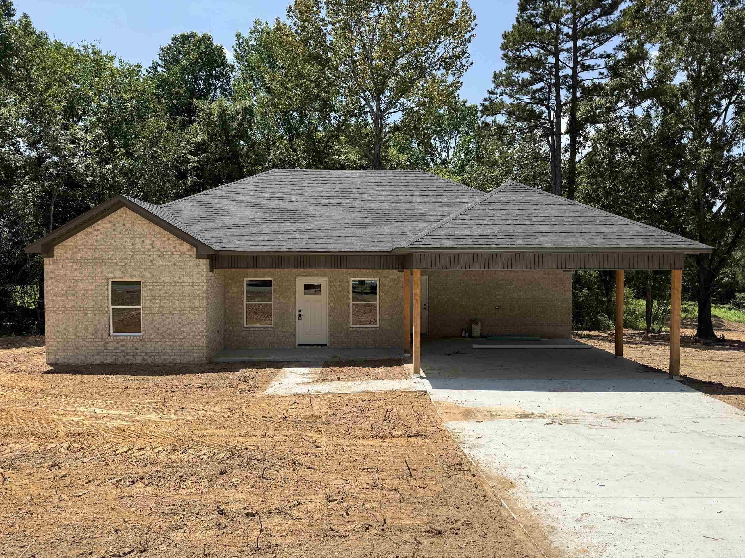 Welcome home to this beautifully crafted new construction brick home, nestled among mature trees on a spacious lot. This thoughtfully designed 3-bedroom, 2-bathroom residence offers the perfect blend of classic charm and modern living. Step inside to discover an open, light-filled living area with recessed lighting and fresh finishes throughout. The kitchen is a standout feature, boasting an oversized island, custom cabinetry, and ample counter space — perfect for entertaining and everyday living. Outside, enjoy a covered carport and a concrete driveway, with plenty of room to landscape and make this property your own. Surrounded by beautiful natural scenery, this home offers privacy and tranquility while remaining conveniently accessible to both Greenbrier and Conway. Completion expected soon — don't miss your chance to be the first to call this one home!