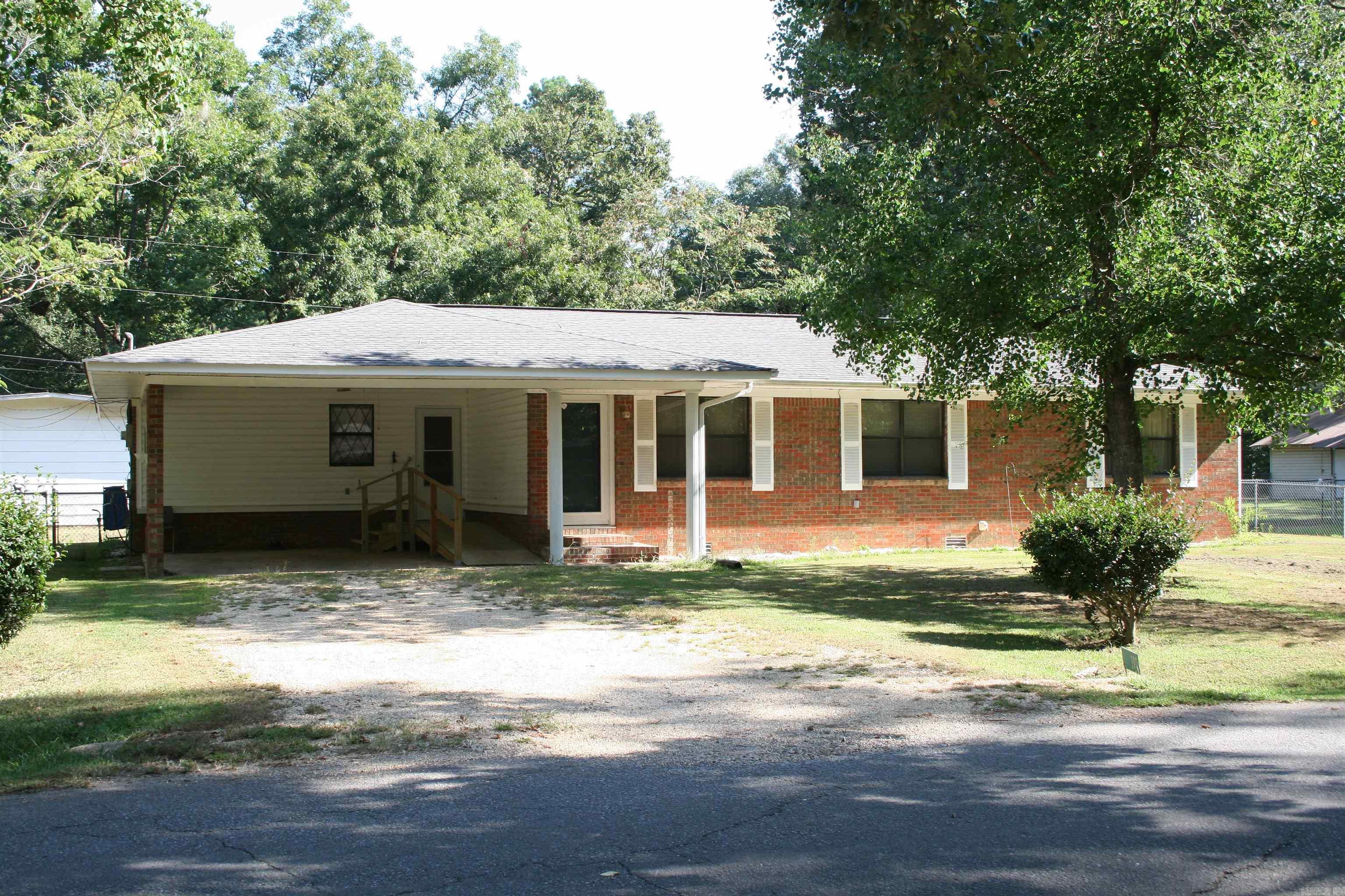 Cute 3-bedroom, 1.5 bath (6/3/1.5) move-in ready brick/vinyl house on corner lot in quiet neighborhood in North Crossett. Eat-in kitchen with spacious custom-built cabinets, pull-out shelves and lazy Susan.  Open floor plan with dining area that as auxiliary gas wall heater.  All 8 ceiling fans with light fixtures.  Large sunroom with wall A/C & electric space heater that convey. New electric water heater in spacious utility/laundry room with shelving.  Roof approx. 9 yrs. & Trane HAVC approx. 11 yrs.  Wheelchair ramp in carport. Huge shop with additional covered & lean-to storage.  Gutters on back of house.  Interior brick wall has been removed, broken floor joists replaced, new sub-flooring installed and Luxury Vinyl Plank Flooring professionally installed in living room, dining area, BR #3, hall bath & hallway.