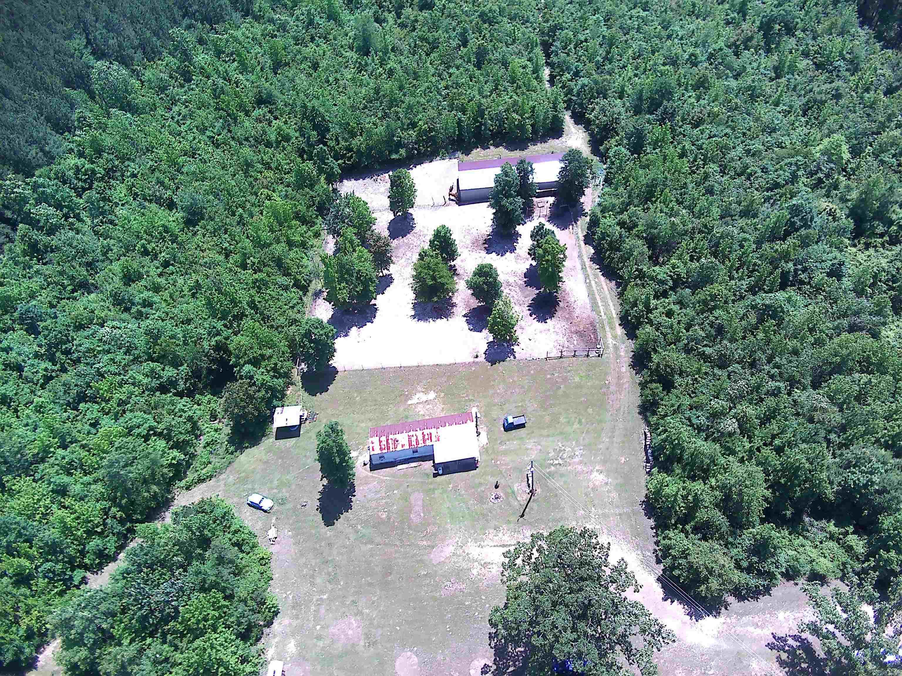 ***7.78 Acres with New 24x70 Metal Shop located on Scenic Skyline Drive between Arkadelphia and Amity*** Beautiful property with multiple locations to build a new home, cabin, hunting retreat or hobby farm. For hunters, there is a covered area with water and electricity for cleaning game as well as "shooting lanes" and multiple places for deer stands. The new 24x70 metal building has overhead doors on each side for pull through convenience and can store all of your toys and equipment. An older mobile home on the property has been updated but is not on a permanent foundation so could easily be relocated for RV hookup. The interior of the mobile home was completely updated in 2024 (including new septic) and is super cute and cozy with a spacious kitchen/living area.  High speed fiber internet by South Central Co-op and water by Kimsey Water.
