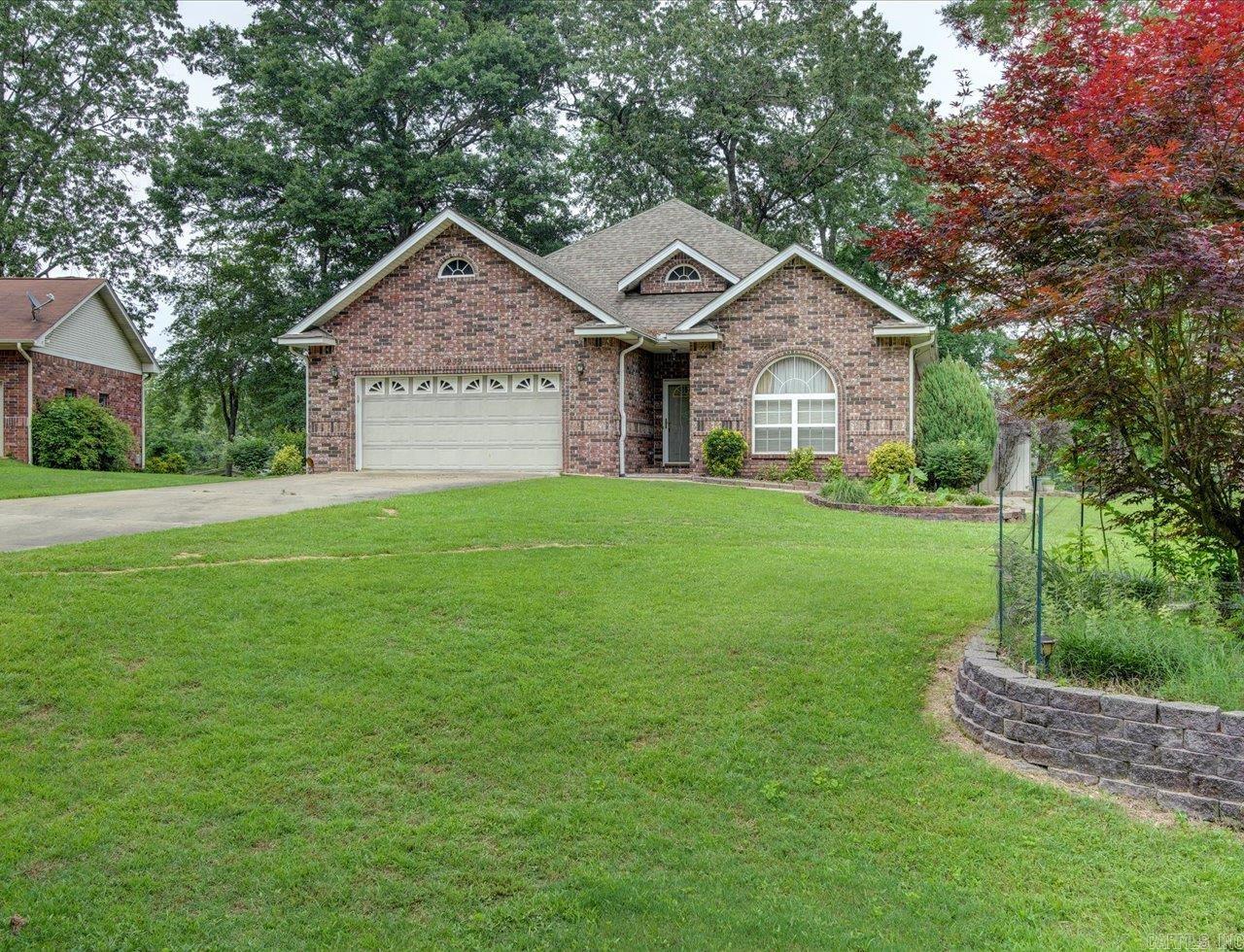 3 bedrooms and 2 bathrooms, this 2202 square foot home is the epitome of comfort. Step inside and you will immediately be greeted by the beautiful laminate floors that flow throughout the main living areas. The entire home has been freshly painted, giving it a bright and inviting feel. One of the most coveted features of this home is the sunroom that overlooks the serene lake. Imagine starting your day with a cup of coffee and a spectacular view, or winding down in the evenings while sipping a glass of wine. But the beauty doesn't stop there. This home also comes with its own boat dock, perfect for a day out on the lake. The property is level to the lake, making it easy for you to access the water for all your water activities. And speaking of activities, this home is ideally located just minutes from golfing and Lake Catherine State Park. You will never run out of things to do in this vibrant community.