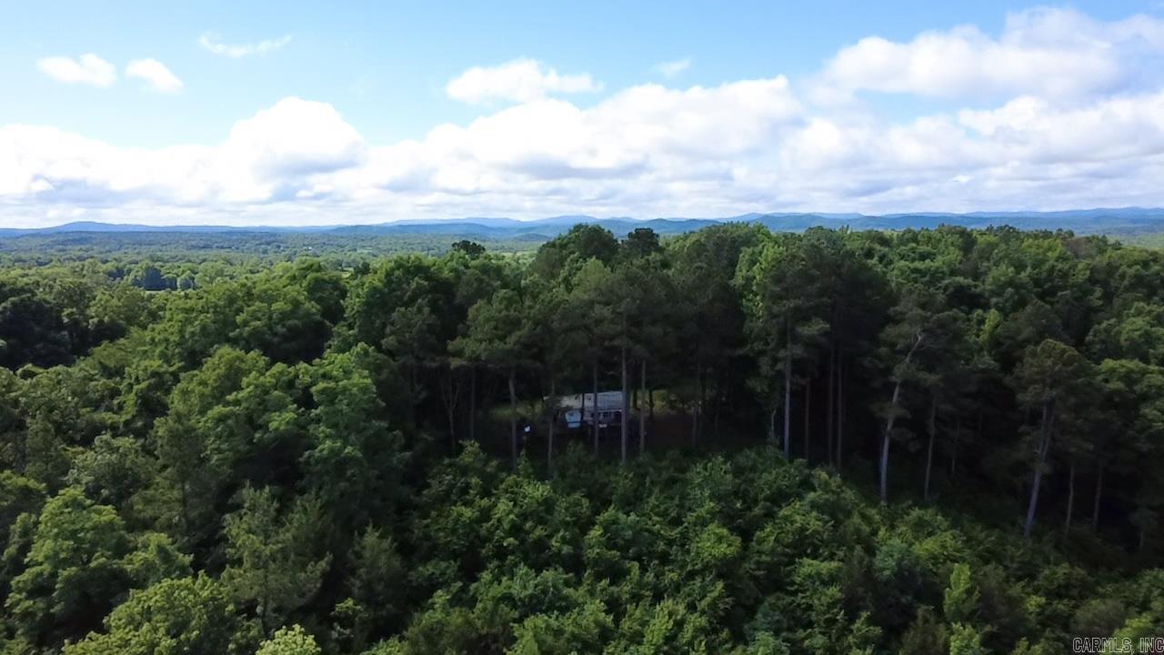 10 wooded acres with gorgeous mountain views! This is your private oasis away from it all!  Plenty of features make this property ready for your outdoor plans: ramp to unload your 4x4, cover for your generator, rain barrels for water supply, 125 yard clearing for the deer field, and more! Just minutes away from the National Forest and ATV trails, this could be your hunting camp or base camp for all things outdoor!  Or just sit and enjoy the view! The 2007 model 18ft camper trailer, deck, and all personal property is included with the sale.