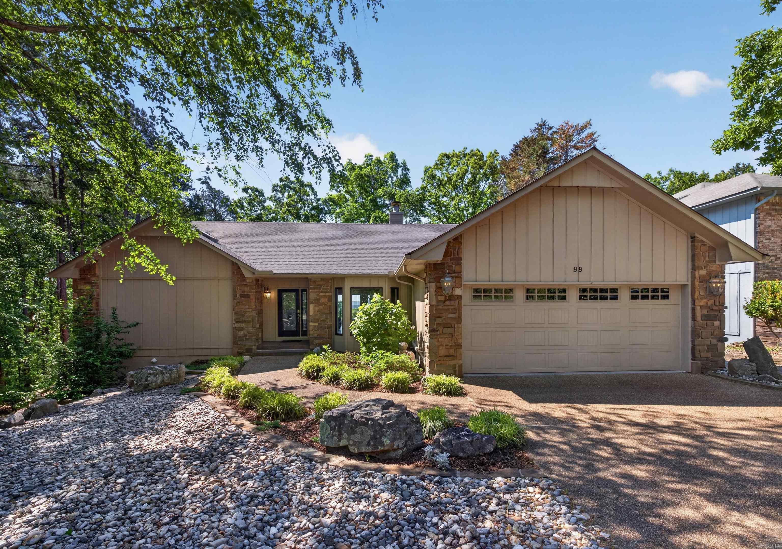This 3400 sq ft home sits in the neighborhood occupying the highest elevation in Hot Springs Village. Enter the front door and take in the panoramic view through expansive glass windows and doors. With morning coffee, enjoy views of distant hills or the lovely yard with water fountain and flower garden. Quality and attention to detail is evident in features of this home such as over window cornices, bullnose edges, custom black walnut cabinets and floor to ceiling designer tile in all bathrooms. Cooking is a joy with kitchen features like touch activated faucets, prep sink with a 2nd disposal, large pot rack, gas range and warming drawer. The large family/media room on the lower level boasts a convenient wet bar with a beverage fridge. Adjacent is a 30 ft. long bonus room easily incorporated into your entertaining space, bedroom or available for whatever your desires dictate. To top it off, there is a 600 sq ft. workshop or artist studio with workbenches, cabinets and extra electrical wiring. The workshop comes with a half-ton utility/golf cart. The 500 gallon buried propane tank serves the gas range, fireplace and HVAC system. Low maintenance tile flooring is throughout the home.