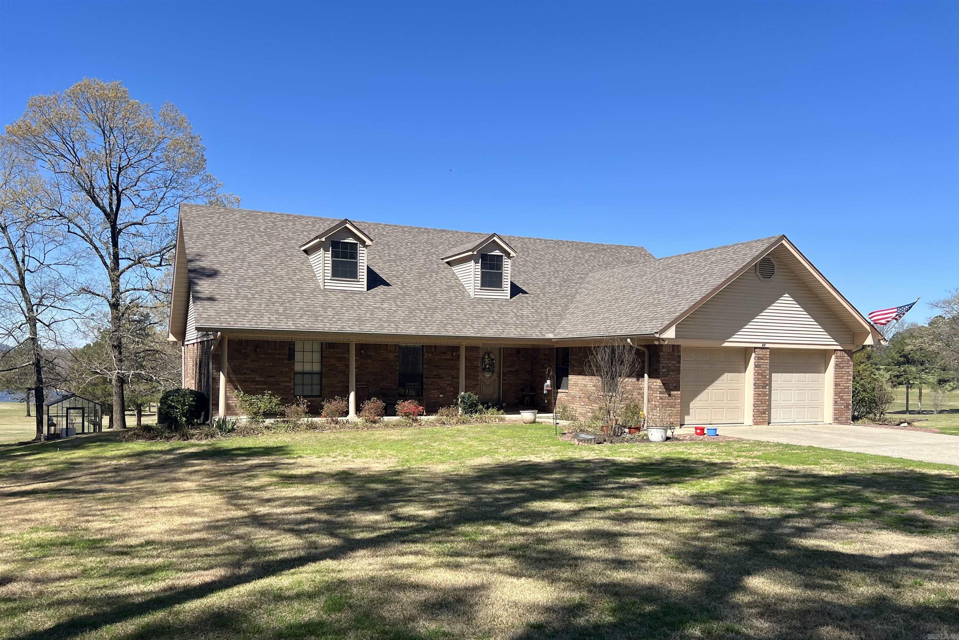 Welcome to 65 Golf Course Rd in Glenwood, a spacious golf-course home designed with incredible storage and functionality in mind. Where comfort, space, and scenic views come together on nearly an acre along the golf course. This spacious brick home offer approximately 4,600 sq ft. of living space with 4 bedrooms, 3 baths, with cinema or game room. 2 separate car garages with a large shop, making it ideal for entertaining or enjoying peaceful everyday living. Step inside to find a generous living area, a cozy fireplace, and large windows that brings in natural light and beautiful golf-course views. Sunroom perfect for relaxing mornings with coffee or unwinding in the evenings while overlooking the greens. Outside the property offers mature trees, a large deck, and plenty of room to host friends, gardening, or simply enjoy the quiet surroundings. No Fees, unrestricted, or Zoning restrictions.
