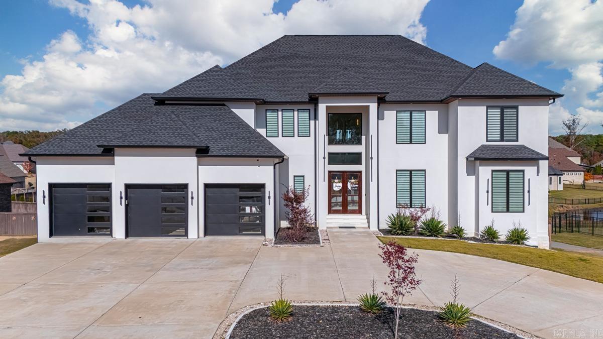 Check out this 6,000 sqft estate in Benton's prestigious Hurricane Lake Estates community suited for hosting and entertainment. This impressive property features 5 beds, 6 full baths, offering ample space for family and guests. Open kitchen, complete with a hidden butler's pantry, custom cabinetry, stainless steel appliances, and modern fixtures. An interior balcony overlooks the expansive main living room offering 22' ceilings, enhancing the open-concept design. The owner's suite is a haven of luxury with a huge walk-in shower and tub combo, accompanied by a generous closet. The home includes a fully finished walk-out basement, whole-house generator, storm shelter room, theater room, sauna, and a convenient laundry chute. It is equipped with a lawn sprinkler system and an oversized three-car garage. Enjoy breathtaking views of Hurricane Lake from the rear wrap-around balconies. The property is located in a gated community with access to Benton's A-rated school district and amenities such as a community pool, tennis and pickleball courts, a playground, and a clubhouse providing sophisticated living in a premium location. #arkansasrealestate #bentonarkansas #hurricanelake