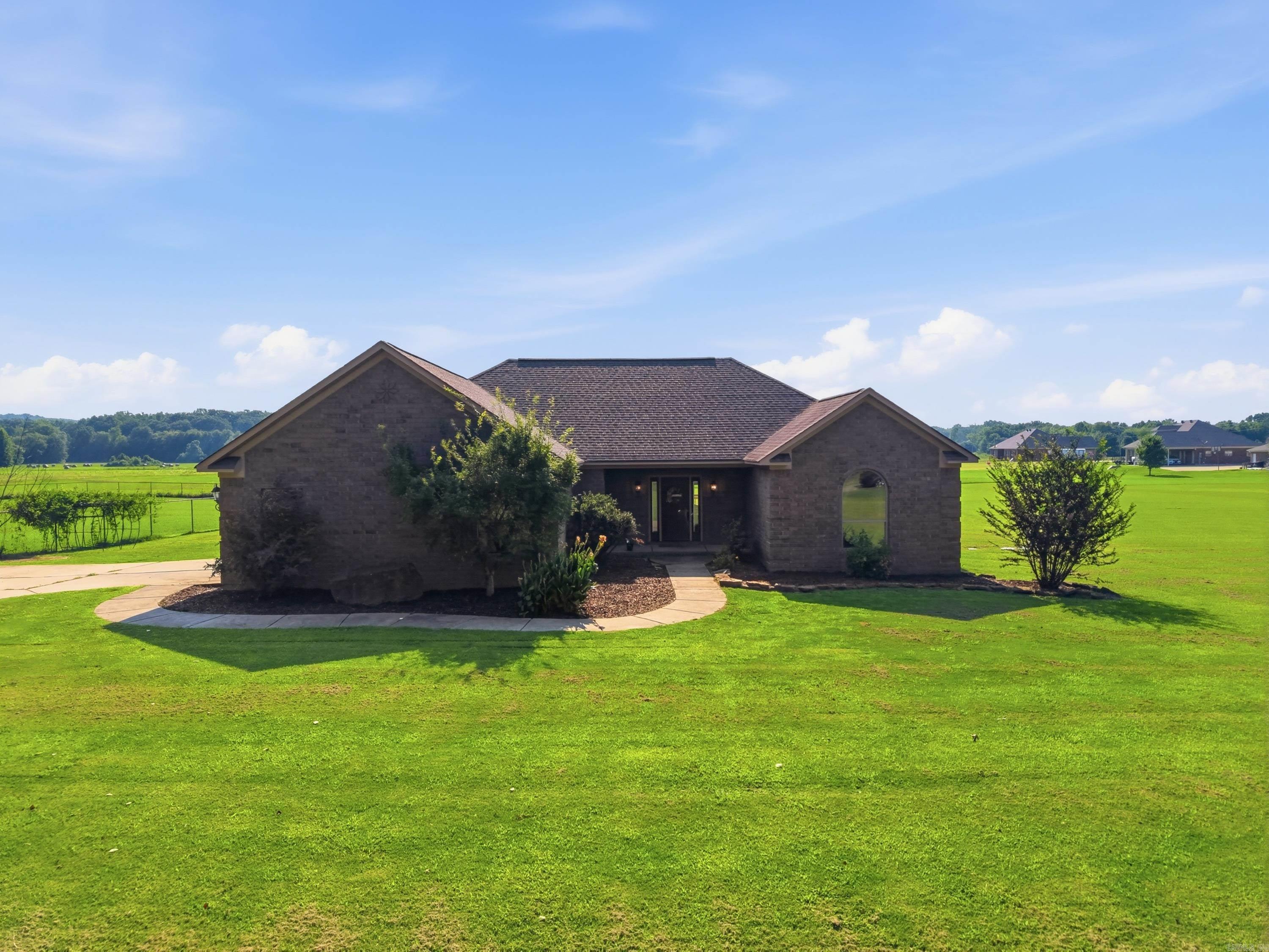 Welcome to 10 Parkway Rd in the desirable Wooster area of Greenbrier, Arkansas. Homebuyers searching for homes w/ acreage in Greenbrier AR near Conway will appreciate this one level home on nearly 1.5 acres, located on a quiet dead end road just steps from Wooster City Park. This 4 bedroom, 2 bathroom home features a desirable open split floor plan designed for comfortable living & entertaining. The spacious kitchen offers granite countertops, a breakfast bar, abundant cabinetry, stainless steel appliances, eat in dining area & kitchen refrigerator is included! The private primary suite features dual vanities, soaking tub, separate shower & 2 walk in closets. 3 additional bedrooms w/ generous closets provide plenty of space for family, guests, or an office. Start your mornings with coffee on the large covered back porch while enjoying beautiful sunrises & peaceful views. With nearly 1.5 acres, you’ll have room to relax, play, or create your ideal outdoor retreat. Conveniently located just minutes from Greenbrier schools, Conway, and an easy commute to Little Rock, this property offers the perfect blend of space, location, and lifestyle. Schedule your private tour today!