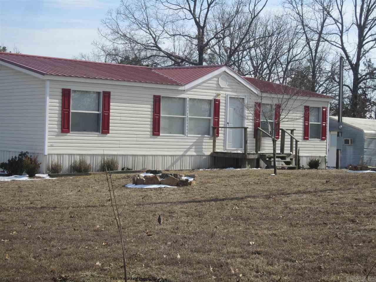 8+/- acre property with a view includes forested hillside, Extra Storage Space and a well maintained Mobile Home. Metal Roof with a Large deck, this split floorplan home features 3 bedrooms, 2 bathrooms, Kitchen, and living rooms. 1/4 mile County Road Frontage provides  plenty of space to place a second mobile home if desired. Owner may consider owner financing.
